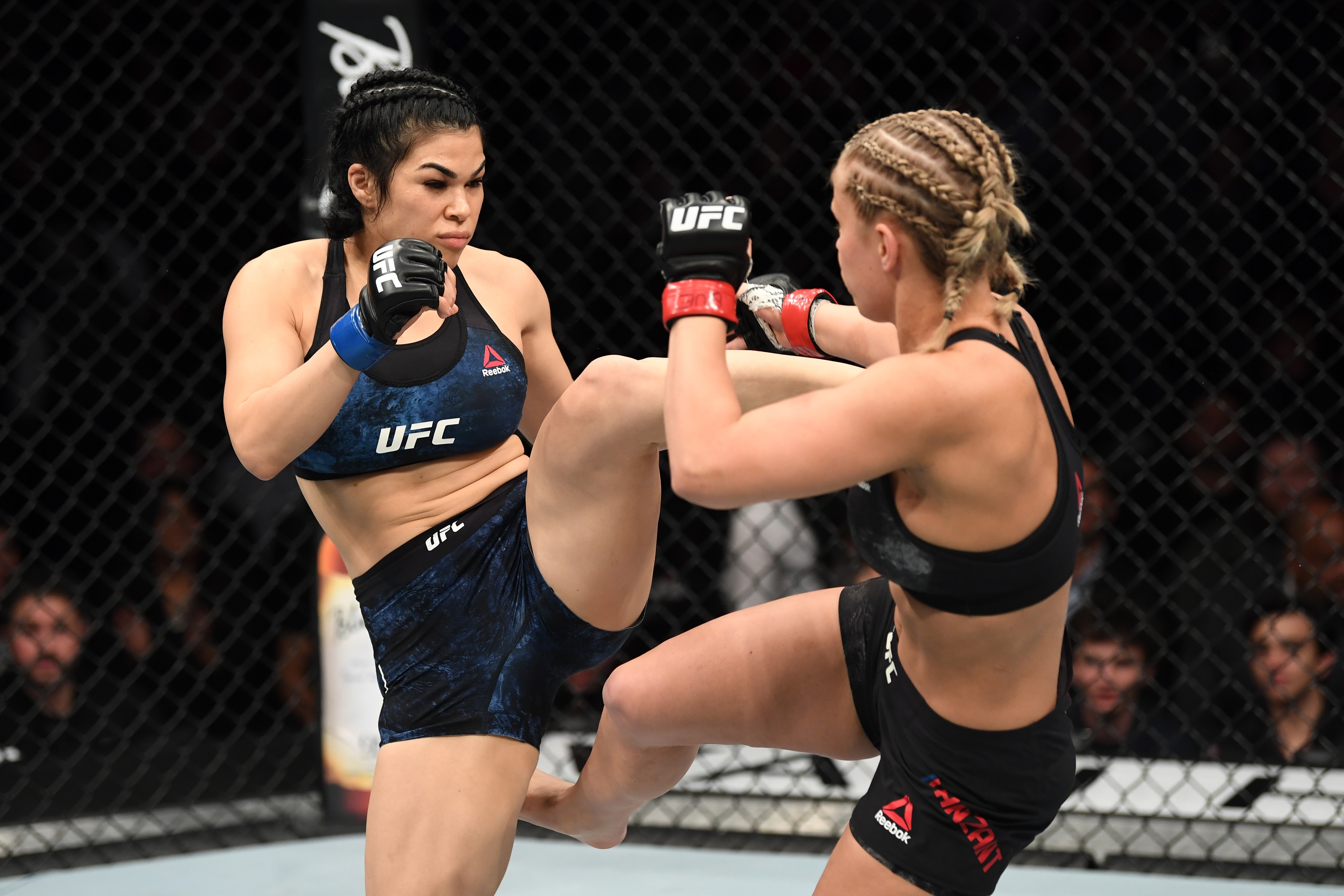 NEW YORK, NY - JANUARY 19:  (L-R) Rachael Ostovich kicks Paige VanZant in their women's flyweight bout during the UFC Fight Night event at the Barclays Center on January 19, 2019 in the Brooklyn borough of New York City. (Photo by Josh Hedges/Zuffa LLC/Zuffa LLC via Getty Images)