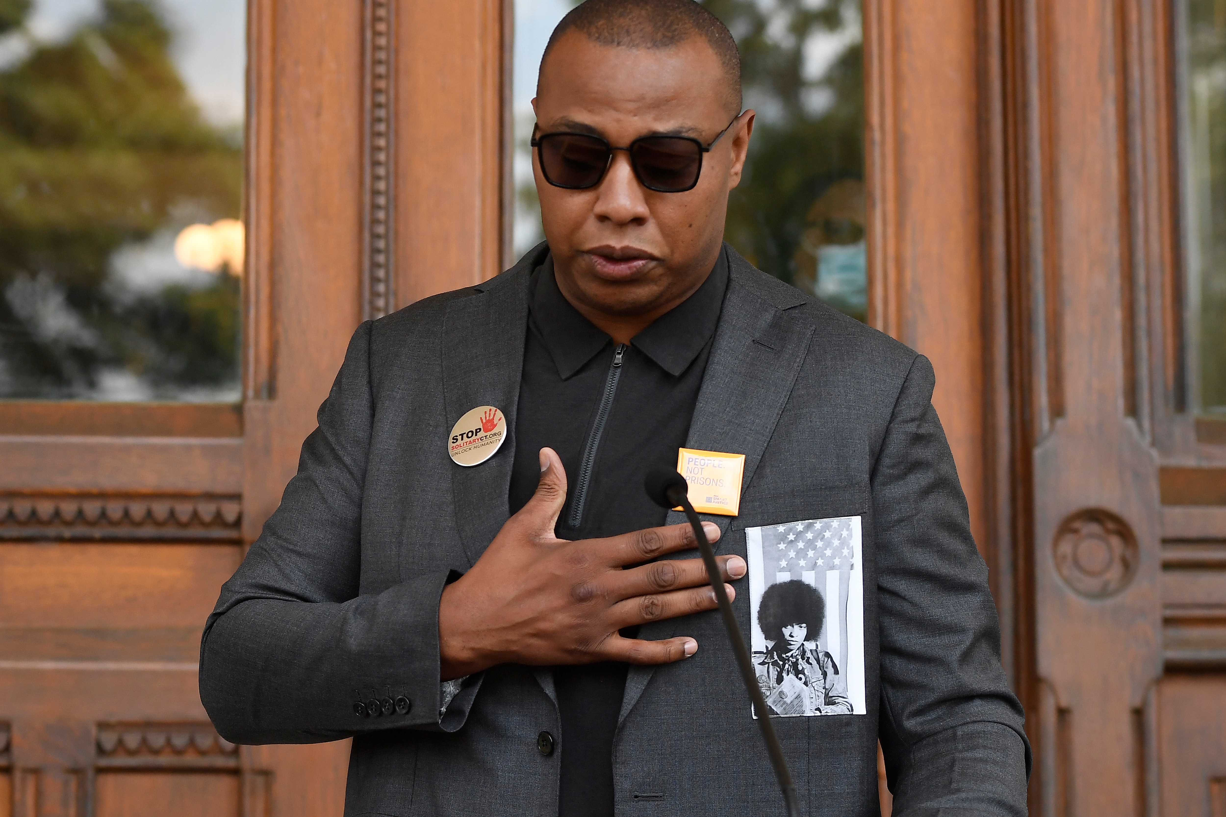 Former UConn and NBA star Caron Butler speaks at a news conference at the Connecticut State Capitol to urge Gov. Ned Lamont to sign legislation that passed which strictly limits the use of solitary confinement and other forms of inmate isolation in prisons, Monday, June 7, 2021 in Hartford, Conn. (AP Photo/Jessica Hill)