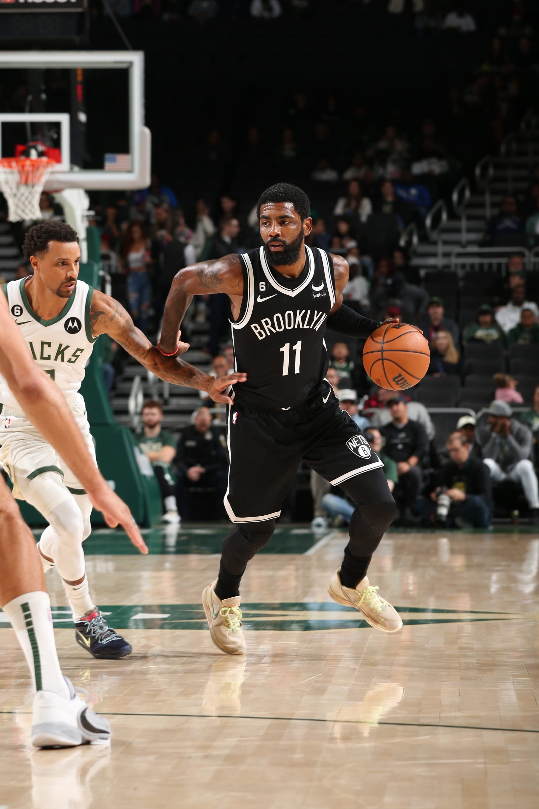 MILWAUKEE, WI - OCTOBER 12: Kyrie Irving #11 of the Brooklyn Nets handles the ball during the game against the Milwaukee Bucks on October 12, 2022 at the Fiserv Forum Center in Milwaukee, Wisconsin. NOTE TO USER: User expressly acknowledges and agrees that, by downloading and or using this Photograph, user is consenting to the terms and conditions of the Getty Images License Agreement. Mandatory Copyright Notice: Copyright 2022 NBAE (Photo by Gary Dineen/NBAE via Getty Images).