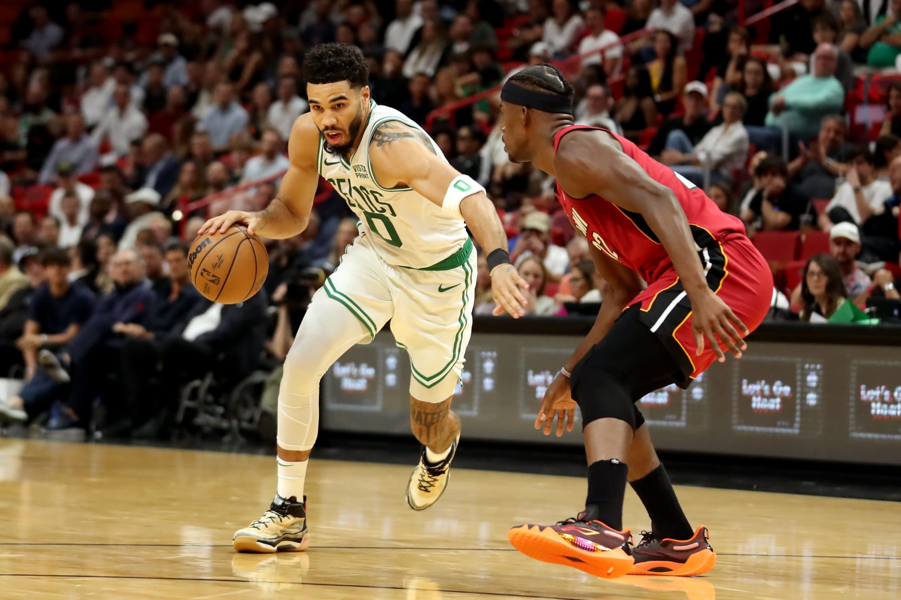 MIAMI, FLORIDA - OCTOBER 21: Jayson Tatum #0 of the Boston Celtics drives against Jimmy Butler #22 of the Miami Heat during the first quarter of the game at FTX Arena on October 21, 2022 in Miami, Florida. NOTE TO USER: User expressly acknowledges and agrees that, by downloading and or using this photograph, User is consenting to the terms and conditions of the Getty Images License Agreement. (Photo by Megan Briggs/Getty Images)