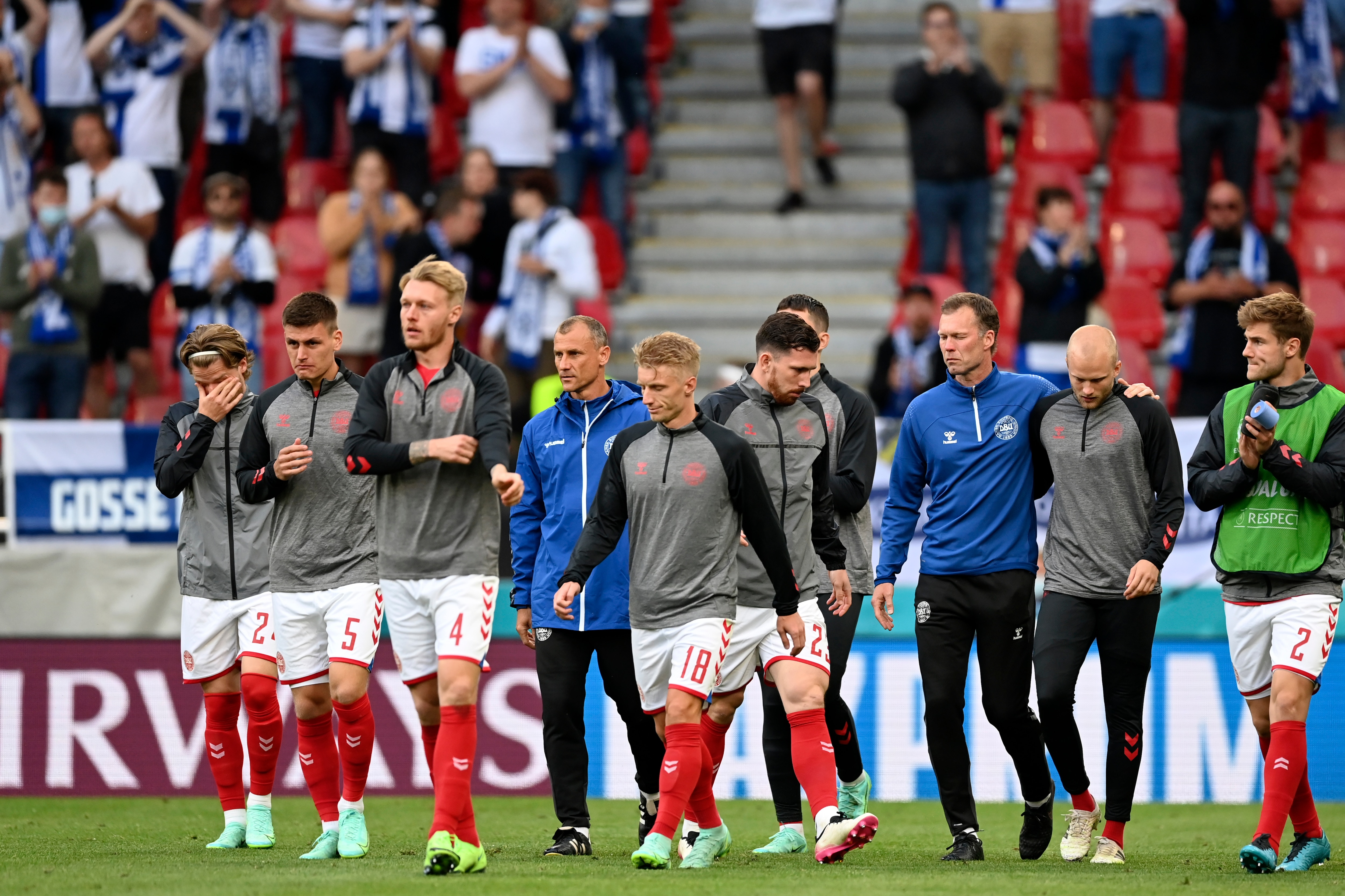 Denmark players return to the pitch to resume the match suspended earlier when Denmark's Christian Eriksen collapsed on the pitch and had to be taken to hospital during the Euro 2020 soccer championship group B match between Denmark and Finland at Parken Stadium in Copenhagen, Saturday, June 12, 2021. (Stuart Franklin/Pool via AP)