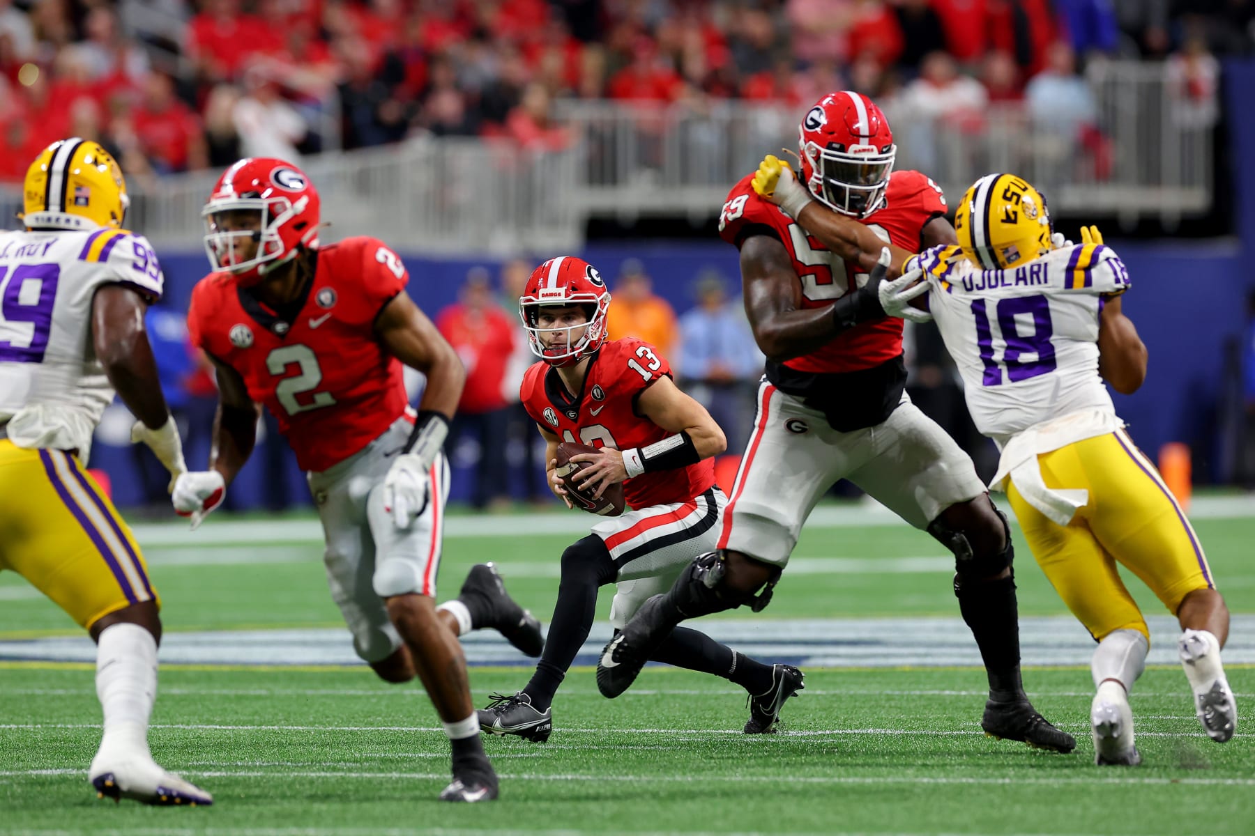 ATLANTA, GEORGIA - DECEMBER 03: Stetson Bennett #13 of the Georgia Bulldogs scrambles against the LSU Tigers during the second quarter in the SEC Championship game at Mercedes-Benz Stadium on December 03, 2022 in Atlanta, Georgia. (Photo by Kevin C. Cox/Getty Images)