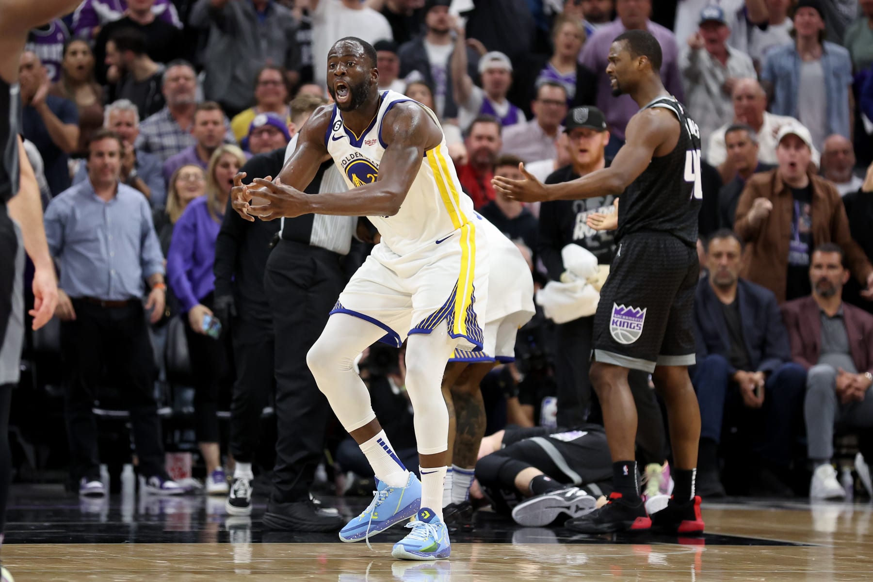 SACRAMENTO, CALIFORNIA - APRIL 17: Draymond Green (right) #23 of the Golden State Warriors reacts after he got tangled with  Domantas Sabonis #10 of the Sacramento Kings in the second half during Game Two of the Western Conference First Round Playoffs at Golden 1 Center on April 17, 2023 in Sacramento, California. Green was issued a flagrant foul 2 on the play, and ejected from the game. NOTE TO USER: User expressly acknowledges and agrees that, by downloading and or using this photograph, User is consenting to the terms and conditions of the Getty Images License Agreement. (Photo by Ezra Shaw/Getty Images)