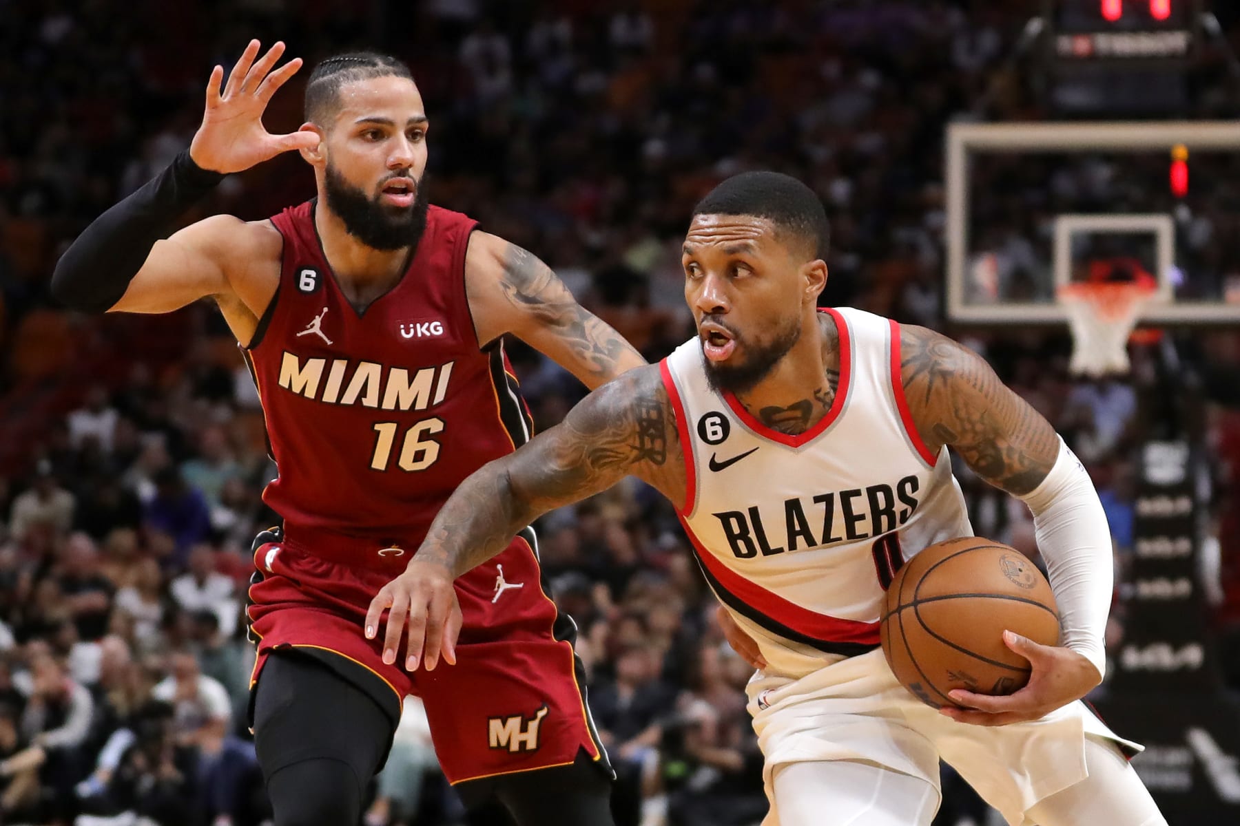 MIAMI, FLORIDA - NOVEMBER 07: Damian Lillard #0 of the Portland Trail Blazers drives past Caleb Martin #16 of the Miami Heat during the second quarter at FTX Arena on November 07, 2022 in Miami, Florida. NOTE TO USER: User expressly acknowledges and agrees that, by downloading and or using this photograph, User is consenting to the terms and conditions of the Getty Images License Agreement. (Photo by Megan Briggs/Getty Images)