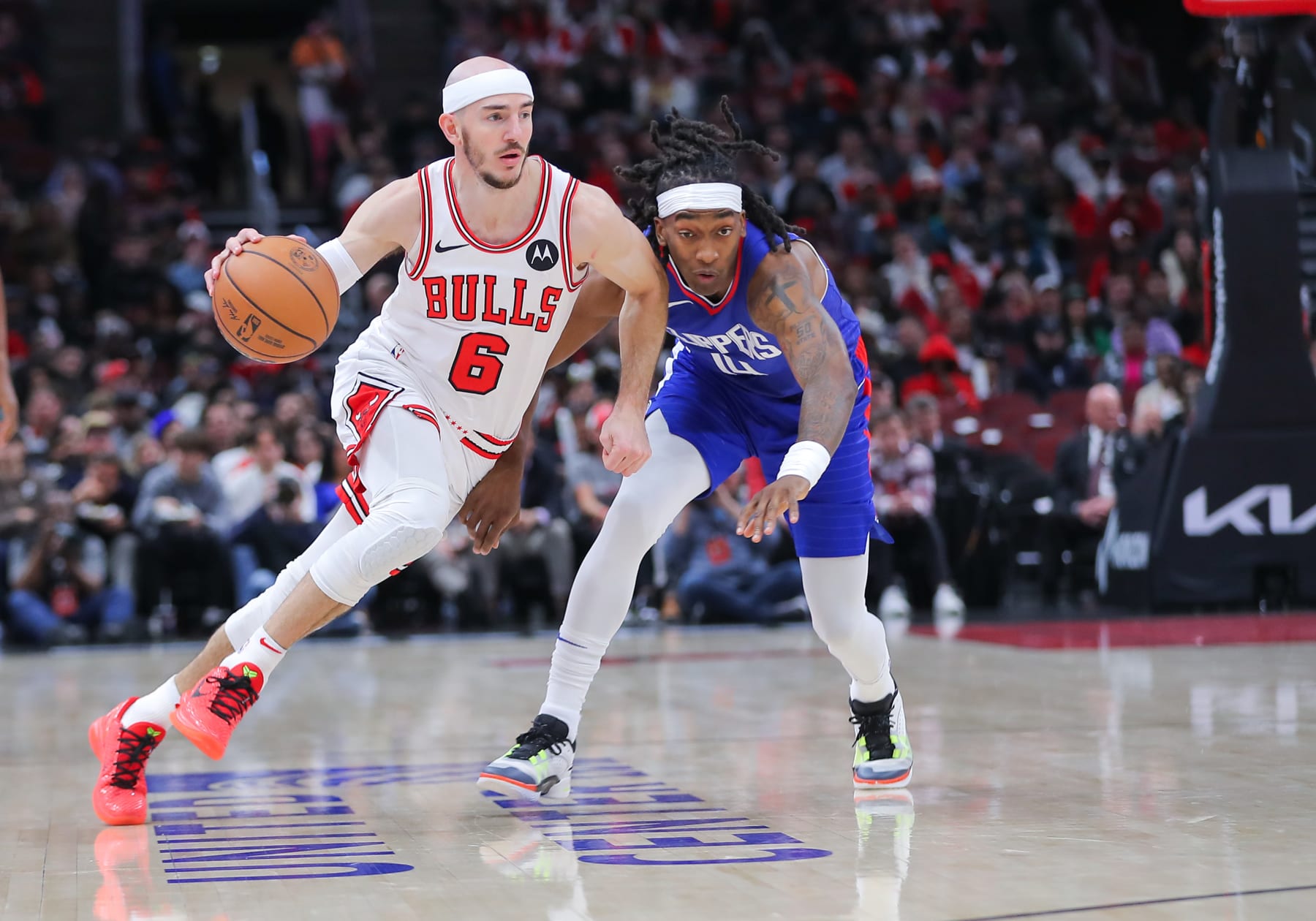 CHICAGO, IL - MARCH 14: Alex Caruso #6 of the Chicago Bulls dribbles the ball against Terance Mann #14 of the LA Clippers during the first half against the LA Clippers at the United Center on March 14, 2024 in Chicago, Illinois. (Photo by Melissa Tamez/Icon Sportswire via Getty Images)