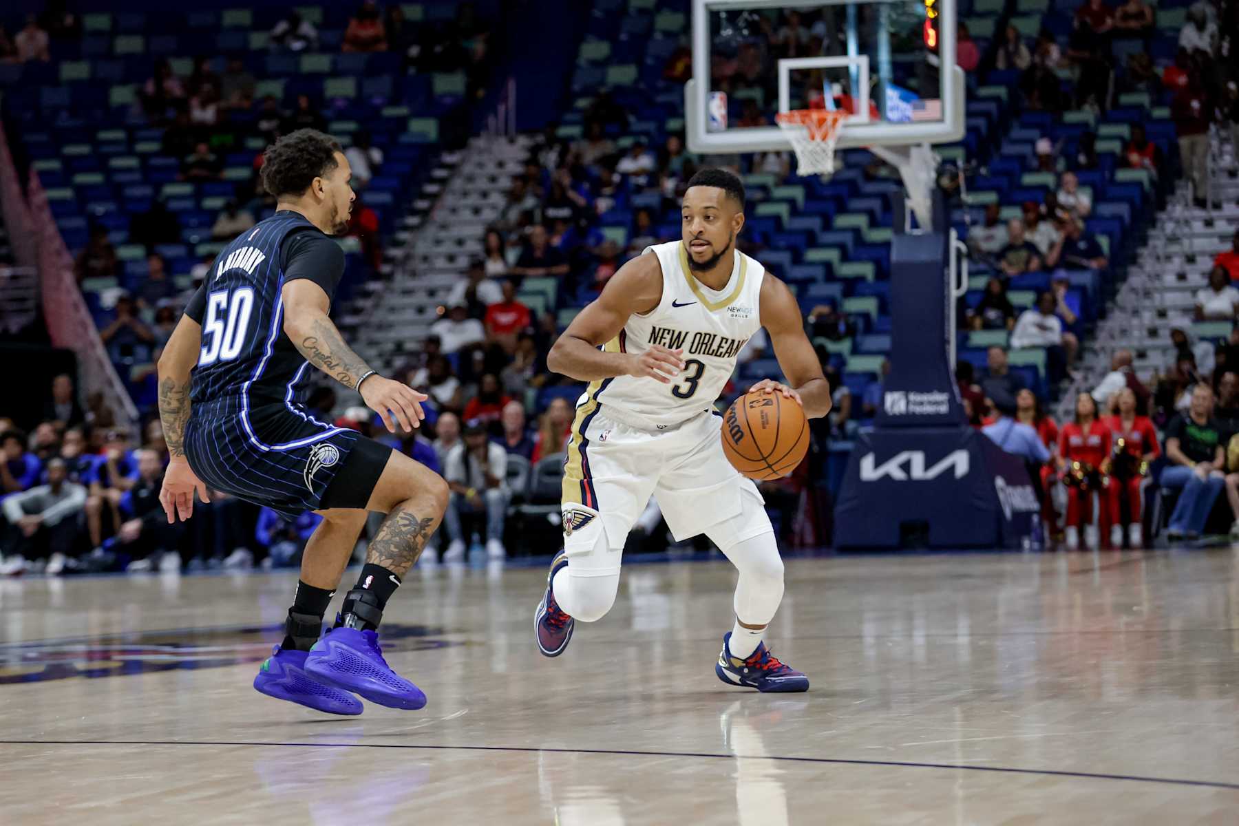NEW ORLEANS, LOUISIANA - OCTOBER 7:  CJ McCollum #3 of the New Orleans Pelicans is defended by Cole Anthony #50 of the Orlando Magic during the first half of a preseason game at the Smoothie King Center on October 7, 2024 in New Orleans, Louisiana. NOTE TO USER: User expressly acknowledges and agrees that, by downloading and or using this photograph, User is consenting to the terms and conditions of the Getty Images License Agreement. (Photo by Derick E. Hingle/Getty Images)