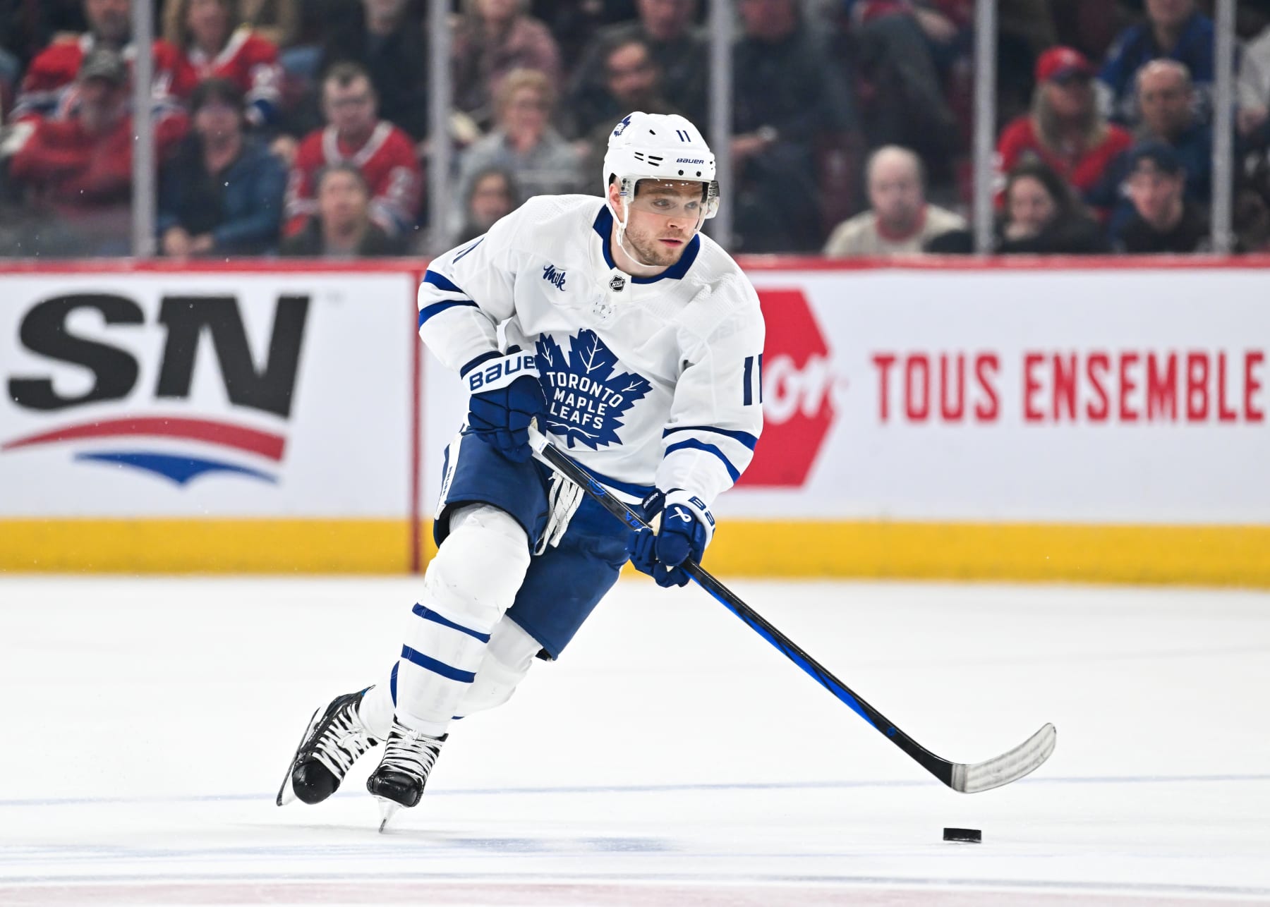 MONTREAL, CANADA - APRIL 06:  Max Domi #11 of the Toronto Maple Leafs skates the puck during the third period against the Montreal Canadiens at the Bell Centre on April 6, 2024 in Montreal, Quebec, Canada.  The Toronto Maple Leafs defeated the Montreal Canadiens 4-2.  (Photo by Minas Panagiotakis/Getty Images)