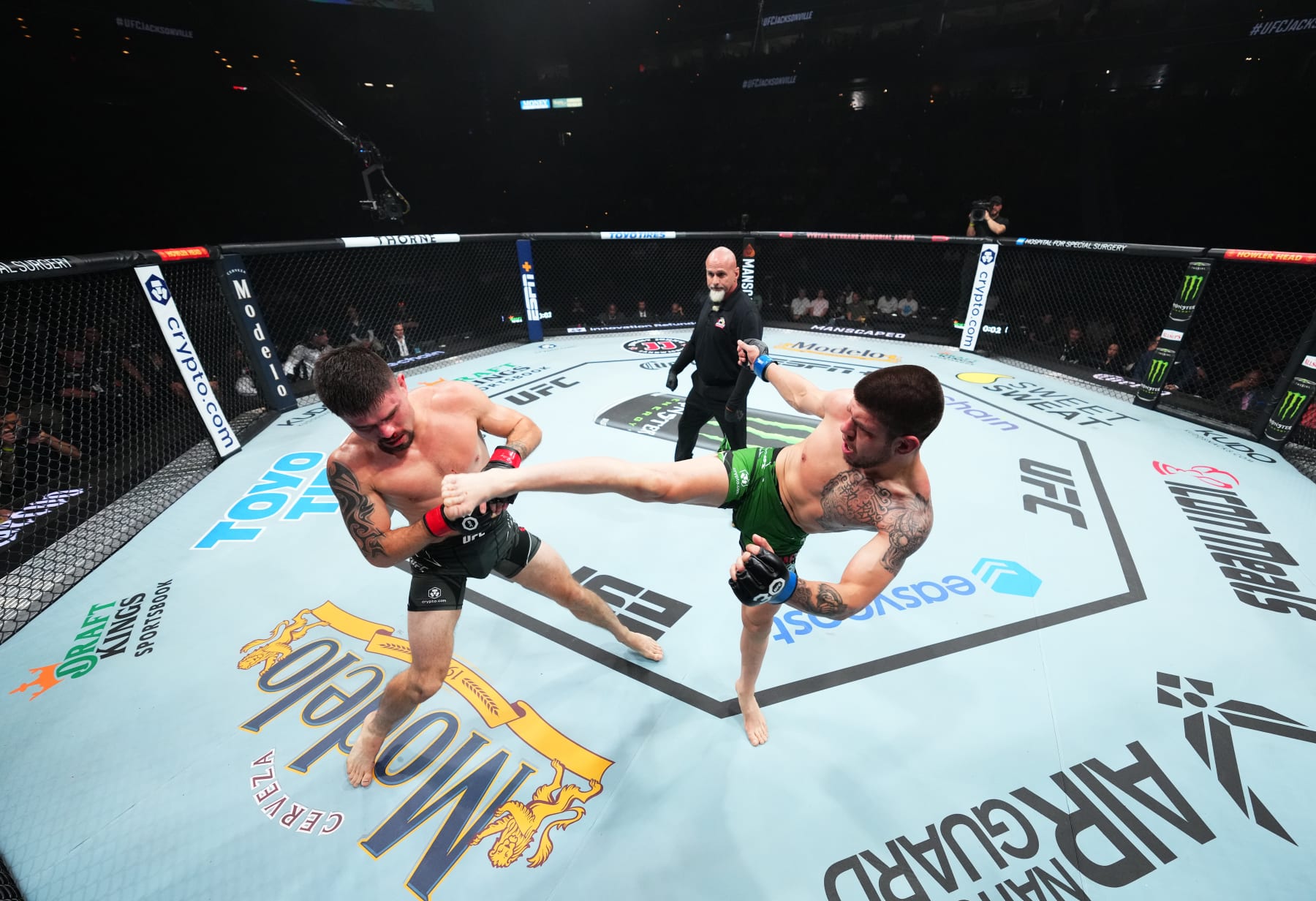 JACKSONVILLE, FLORIDA - JUNE 24:  (R-L) Chepe Mariscal kicks Trevor Peek in their lightweight fight during the UFC Fight Night event at Vystar Veterans Memorial Arena on June 24, 2023 in Jacksonville, Florida. (Photo by Josh Hedges/Zuffa LLC)