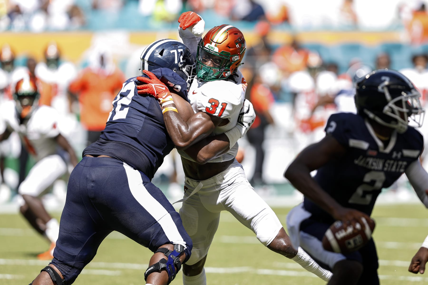 MIAMI GARDENS, FLORIDA - SEPTEMBER 04: Linebacker Isaiah Land #31 of the Florida A&M Rattlers is blocked by Tackle Willis Patrick #72 of the Jackson State Tigerss during the Orange Blossom Classic Game at Hard Rock Stadium on September 04, 2022 in Miami Gardens, Florida. The Tigers defeated the Rattlers 59-3. (Photo by Don Juan Moore/Getty Images)