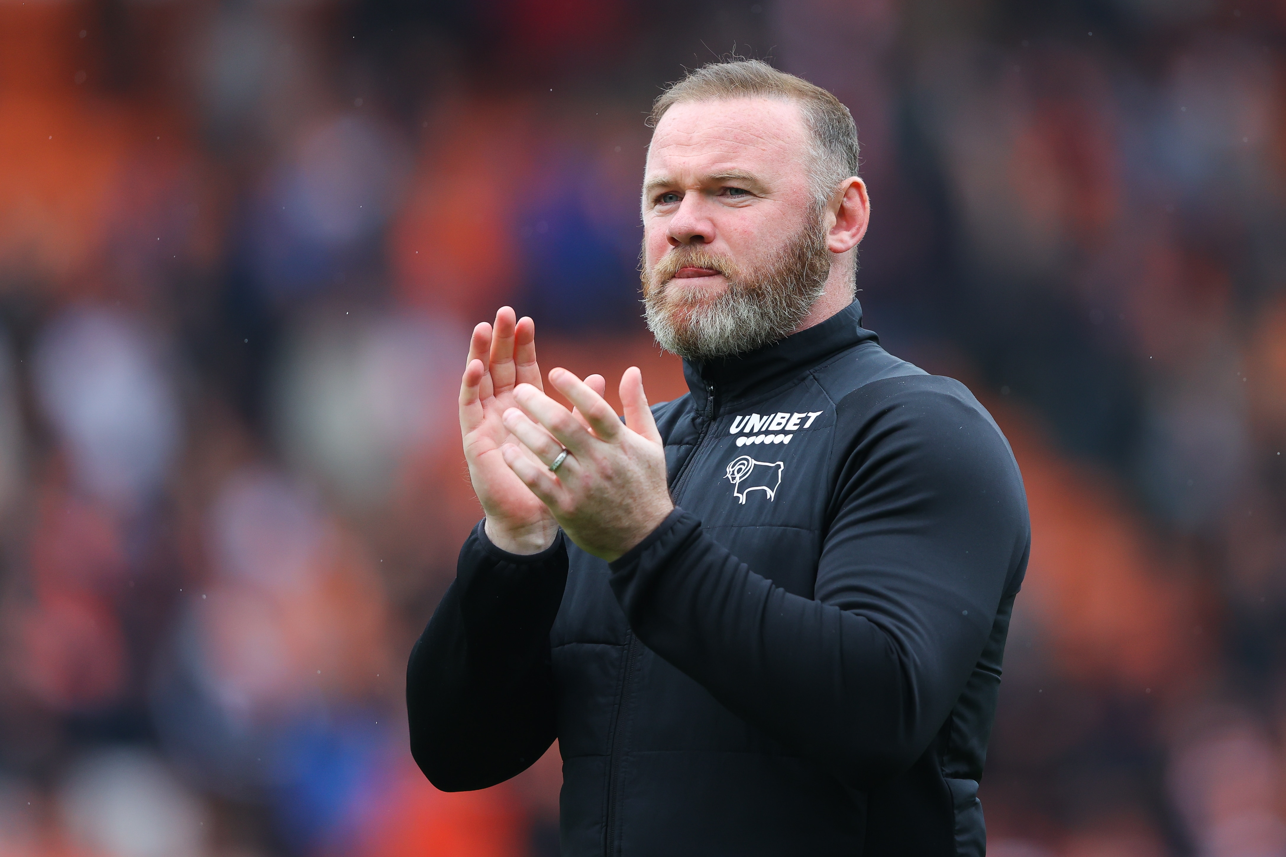 BLACKPOOL, ENGLAND - APRIL 30: Wayne Rooney, manager of Derby County, applauds the visiting support following the Sky Bet Championship match between Blackpool and Derby County at Bloomfield Road on April 30, 2022 in Blackpool, England. (Photo by James Gill/Getty Images)