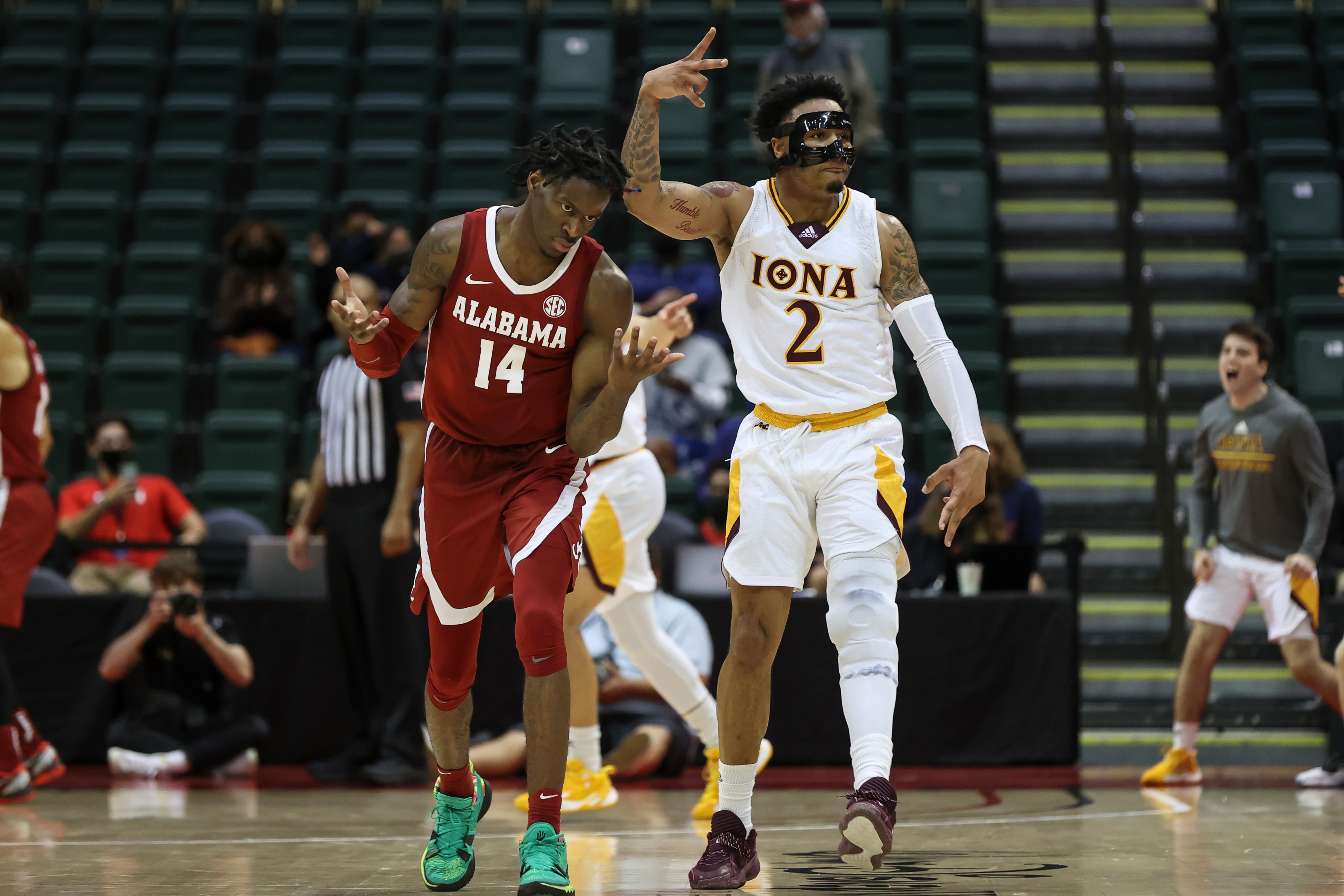 ORLANDO, FL - NOVEMBER 25: Iona Gaels guard Elijah Joiner (2) celebrates as Alabama Crimson Tide guard Keon Ellis (14) reacts to Iona taking the lead in the 2nd half of the ESPN Events Invitational college basketball game between the Alabama Crimson Tide and Iona Gaels on November 25, 2021 at the HP Field House in Orlando, FL. (Photo by Mark LoMoglio/Icon Sportswire via Getty Images)
