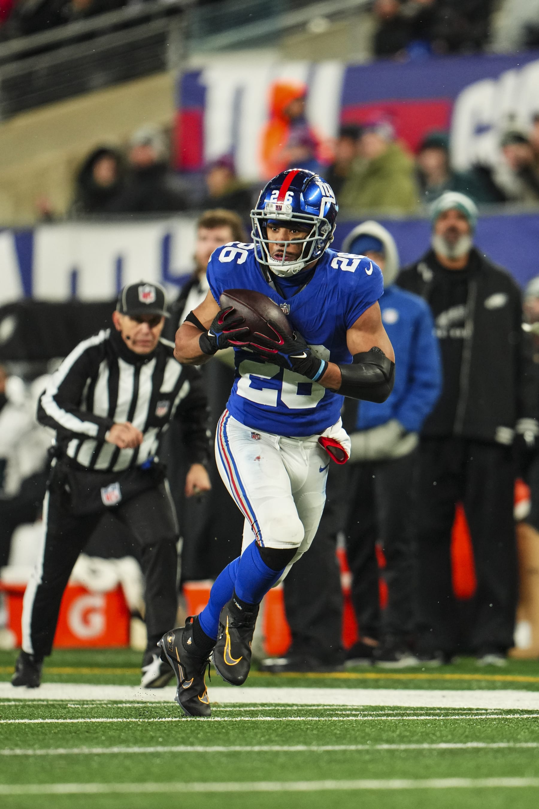 EAST RUTHERFORD, NJ - JANUARY 07: Saquon Barkley #26 of the New York Giants runs the ball during an NFL football game against the Philadelphia Eagles at MetLife Stadium on January 7, 2024 in East Rutherford, New Jersey. (Photo by Cooper Neill/Getty Images)