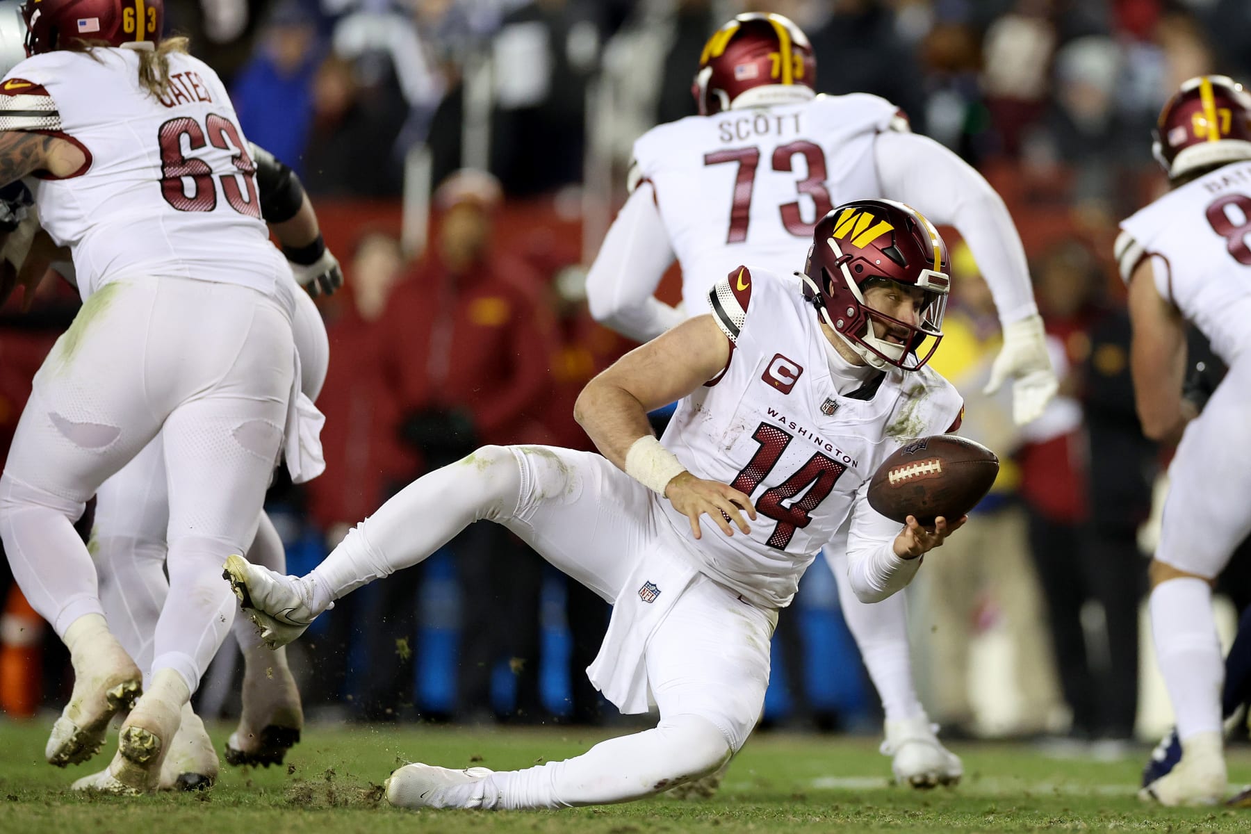 LANDOVER, MARYLAND - JANUARY 07: Sam Howell #14 of the Washington Commanders trips during the fourth quarter against the Dallas Cowboys at FedExField on January 07, 2024 in Landover, Maryland. (Photo by Patrick Smith/Getty Images)