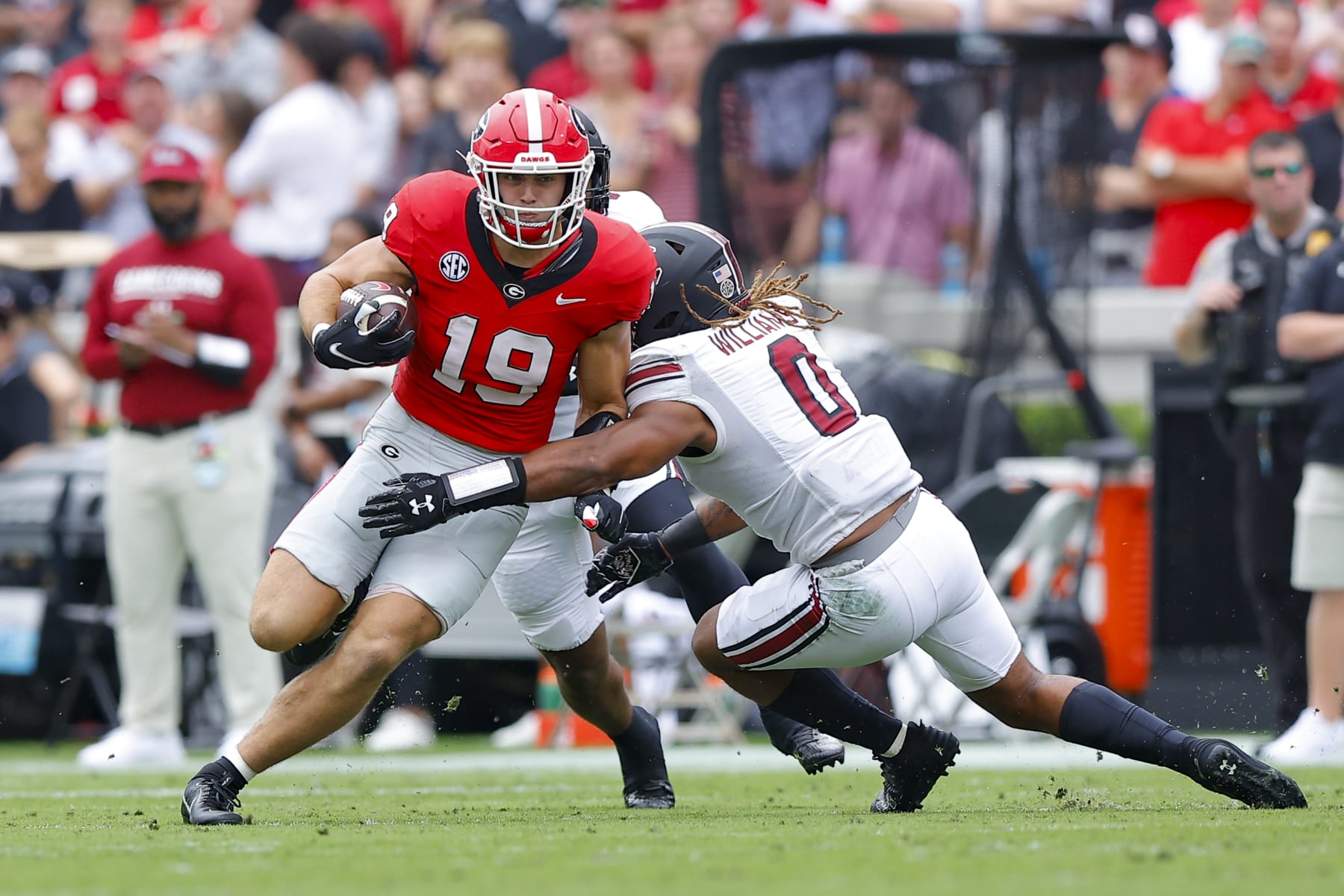 ATHENS, GEORGIA - SEPTEMBER 16: Brock Bowers #19 of the Georgia Bulldogs is tackled by Debo Williams #0 of the South Carolina Gamecocks at Sanford Stadium on September 16, 2023 in Athens, Georgia. (Photo by Todd Kirkland/Getty Images)