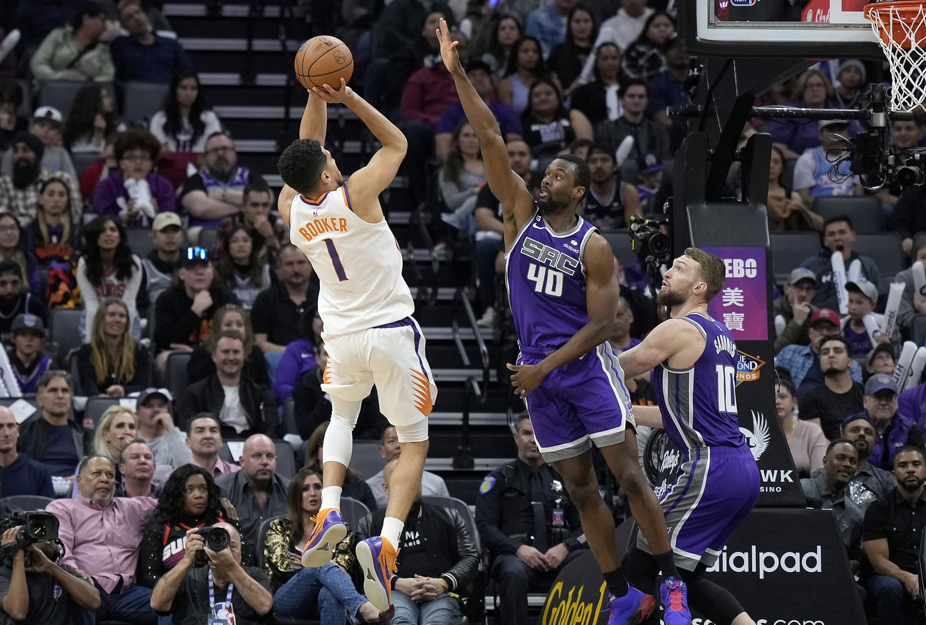 SACRAMENTO, CALIFORNIA - MARCH 24: Devin Booker #1 of the Phoenix Suns shoots over Harrison Barnes #40 of the Sacramento Kings during the fourth quarter in an NBA basketball game at Golden 1 Center on March 24, 2023 in Sacramento, California. NOTE TO USER: User expressly acknowledges and agrees that, by downloading and or using this photograph, User is consenting to the terms and conditions of the Getty Images License Agreement. (Photo by Thearon W. Henderson/Getty Images)