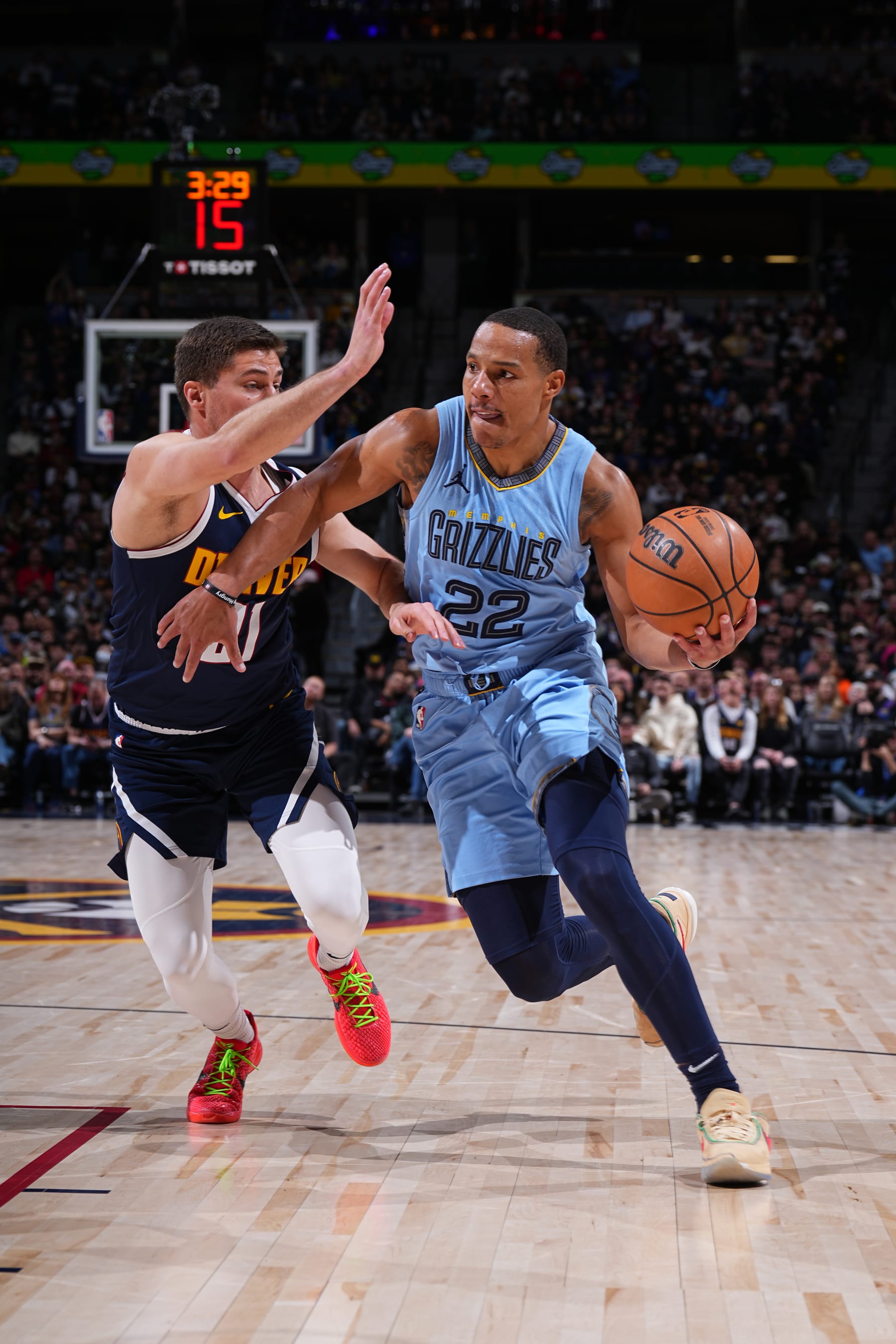 DENVER, CO - MARCH 25: Desmond Bane #22 of the Memphis Grizzlies handles the ball during the game against the Denver Nuggets on March 25, 2024 at the Ball Arena in Denver, Colorado. NOTE TO USER: User expressly acknowledges and agrees that, by downloading and/or using this Photograph, user is consenting to the terms and conditions of the Getty Images License Agreement. Mandatory Copyright Notice: Copyright 2024 NBAE (Photo by Garrett Ellwood/NBAE via Getty Images)