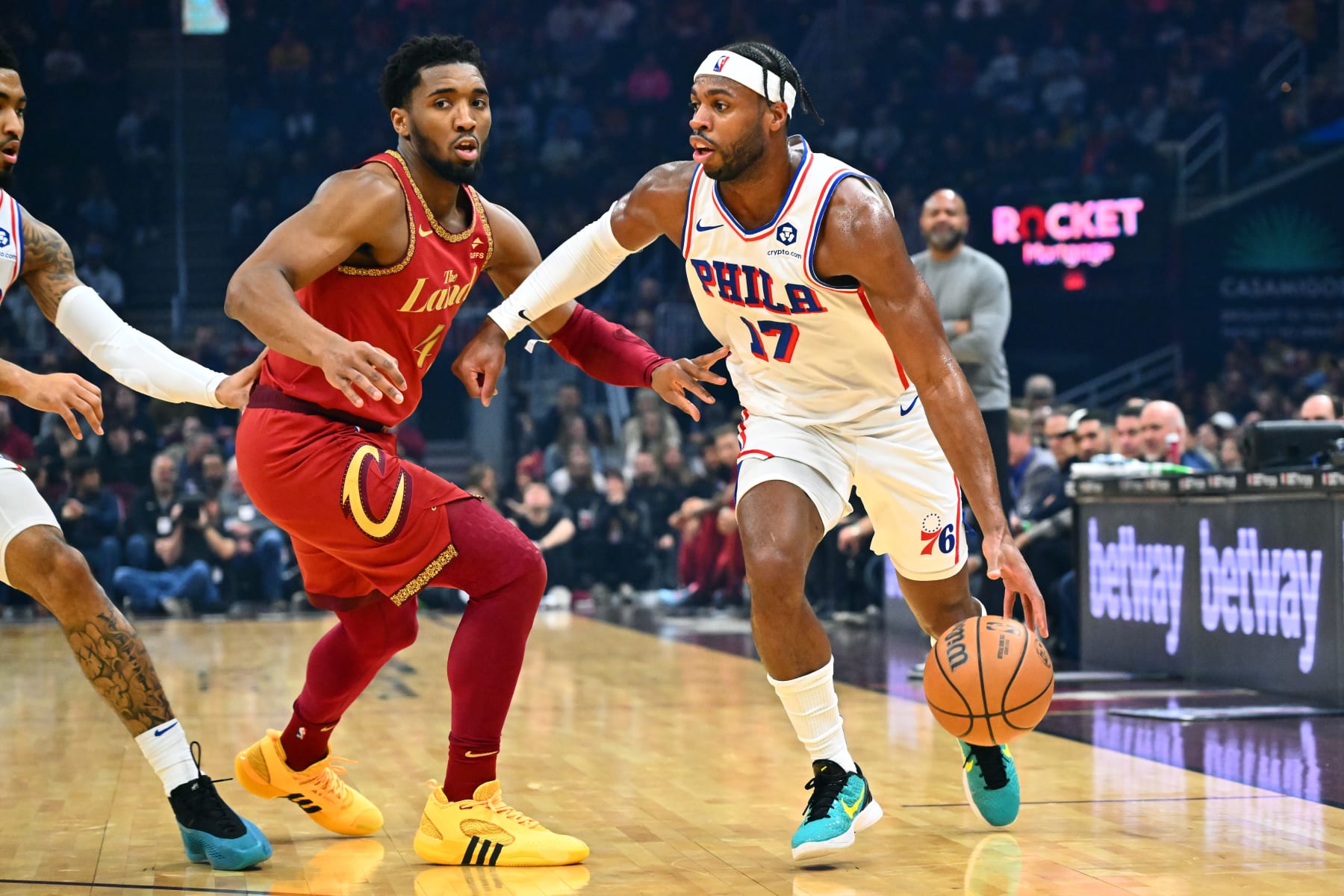 CLEVELAND, OHIO - FEBRUARY 12: Buddy Hield #17 of the Philadelphia 76ers goes around Donovan Mitchell #45 of the Cleveland Cavaliers during the first quarter at Rocket Mortgage Fieldhouse on February 12, 2024 in Cleveland, Ohio. NOTE TO USER: User expressly acknowledges and agrees that, by downloading and or using this photograph, User is consenting to the terms and conditions of the Getty Images License Agreement. (Photo by Jason Miller/Getty Images)