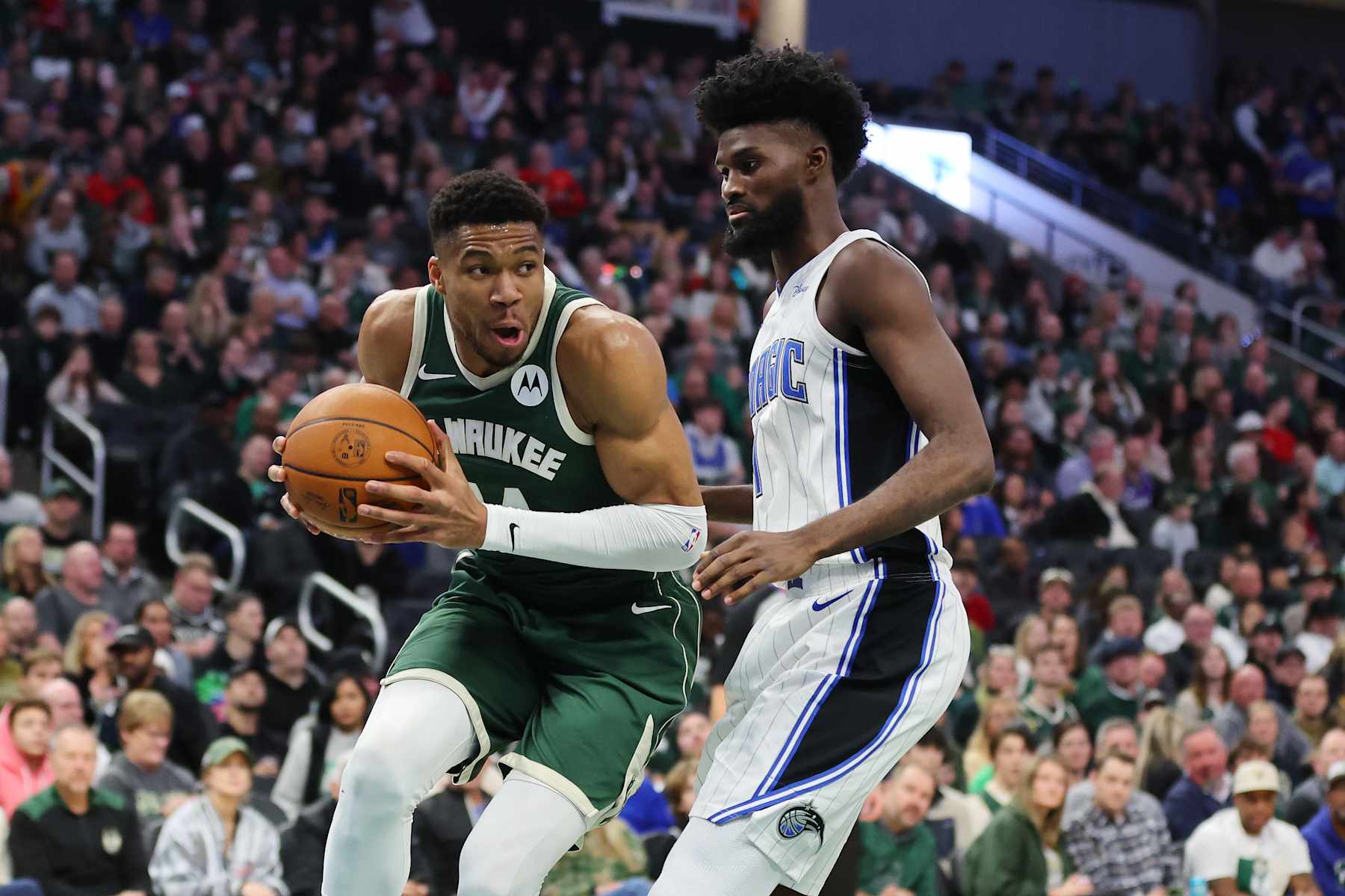 MILWAUKEE, WISCONSIN - DECEMBER 21: Giannis Antetokounmpo #34 of the Milwaukee Bucks is defended by Jonathan Isaac #1 of the Orlando Magic during a game at Fiserv Forum on December 21, 2023 in Milwaukee, Wisconsin. NOTE TO USER: User expressly acknowledges and agrees that, by downloading and or using this photograph, User is consenting to the terms and conditions of the Getty Images License Agreement. (Photo by Stacy Revere/Getty Images)