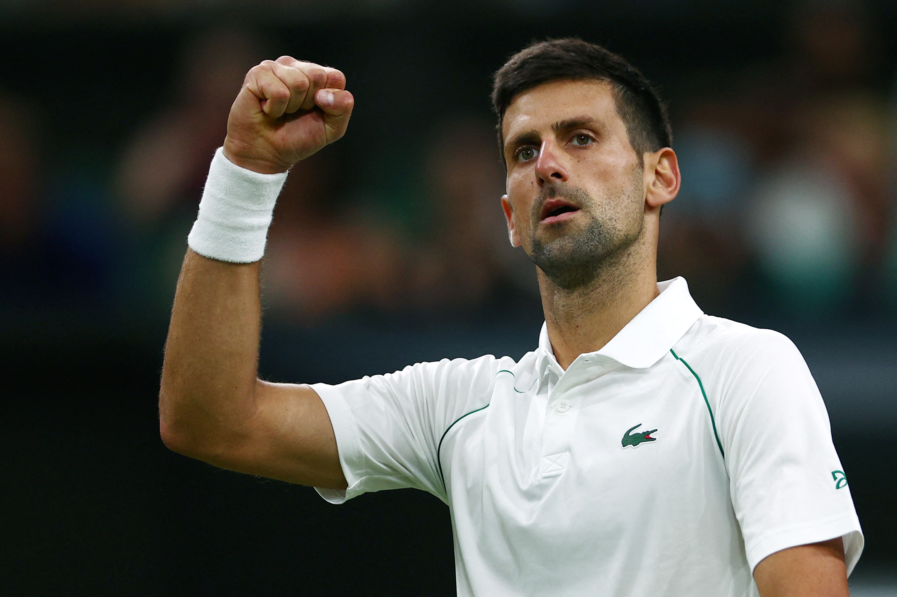 Serbia's Novak Djokovic reacts to breaking Netherlands' Tim van Rijthoven's serve during their round of 16 men's singles tennis match on the seventh day of the 2022 Wimbledon Championships at The All England Tennis Club in Wimbledon, southwest London, on July 3, 2022. - RESTRICTED TO EDITORIAL USE (Photo by Adrian DENNIS / AFP) / RESTRICTED TO EDITORIAL USE (Photo by ADRIAN DENNIS/AFP via Getty Images)