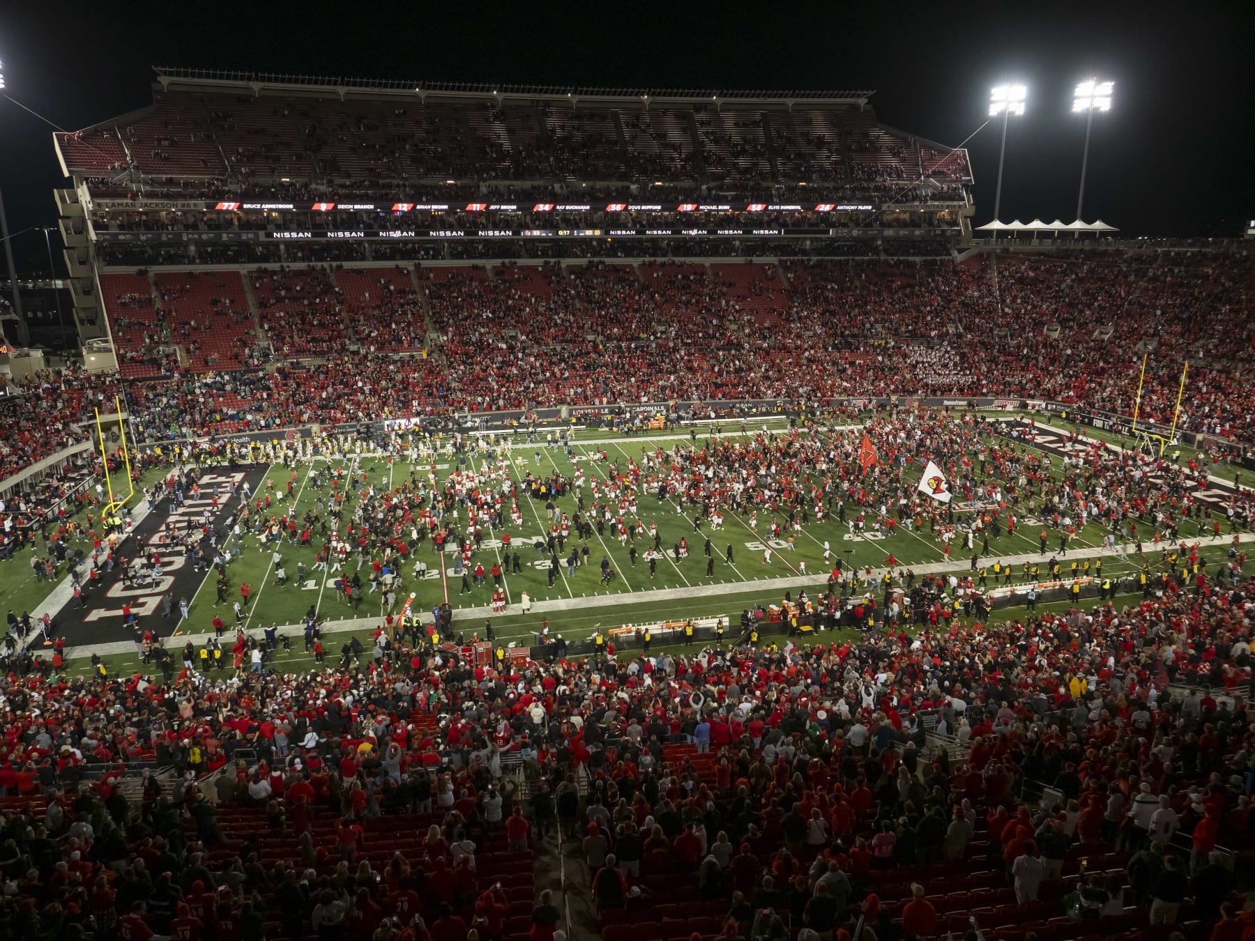 Louisville Cardinals fans storm the field after win over Notre Dame Fighting Irish 