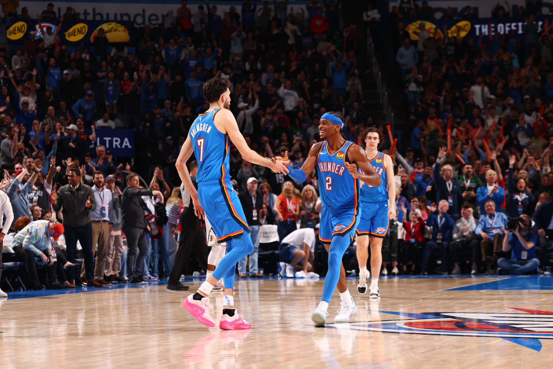 OKLAHOMA CITY, OK - JANUARY 31: Chet Holmgren #7 high fives Shai Gilgeous-Alexander #2 of the Oklahoma City Thunder during the game against the Denver Nuggets on January 31, 2024 at Paycom Arena in Oklahoma City, Oklahoma. NOTE TO USER: User expressly acknowledges and agrees that, by downloading and or using this photograph, User is consenting to the terms and conditions of the Getty Images License Agreement. Mandatory Copyright Notice: Copyright 2024 NBAE (Photo by Zach Beeker/NBAE via Getty Images)