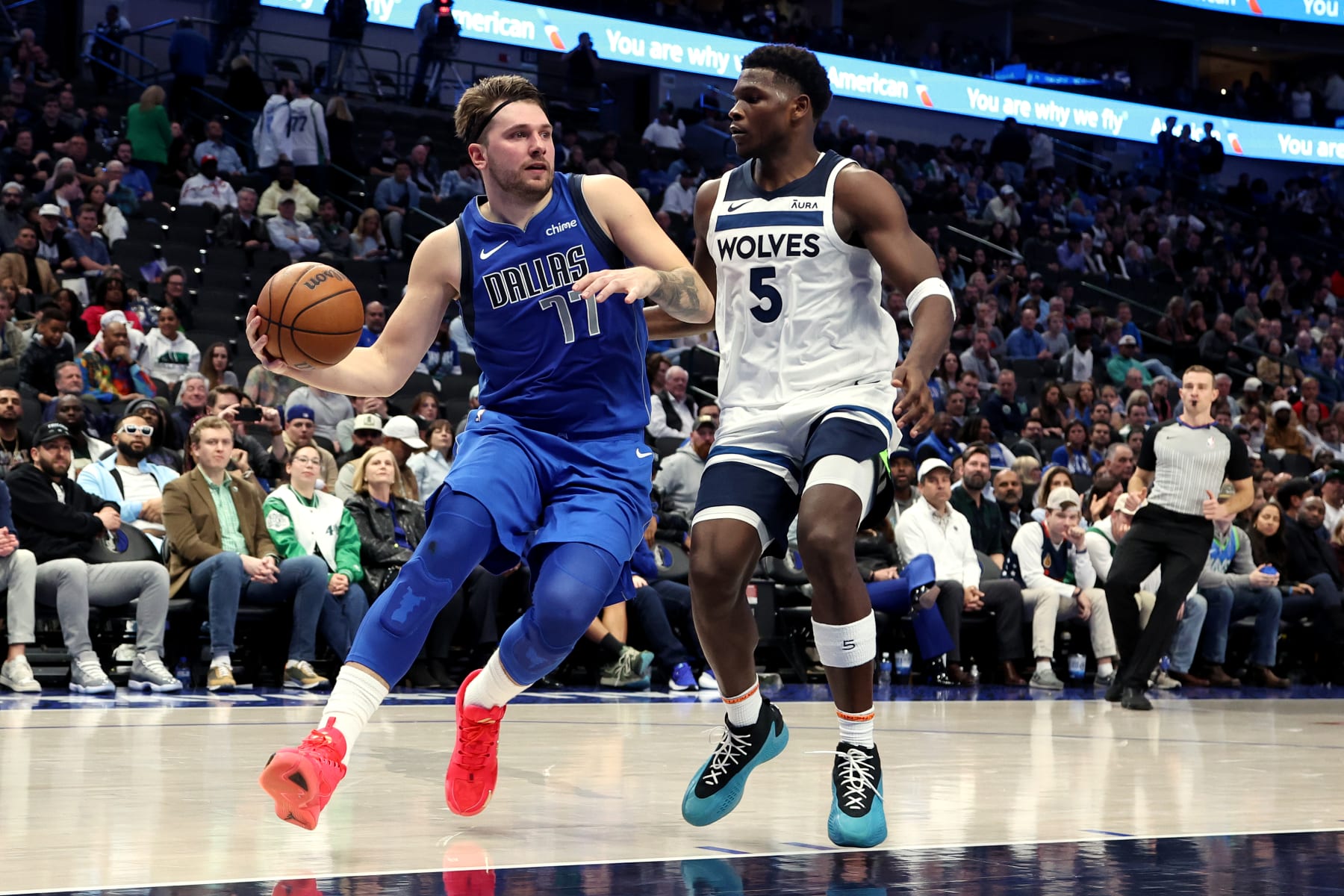 DALLAS, TEXAS - DECEMBER 14: Luka Doncic #77 of the Dallas Mavericks drives to the basket against Anthony Edwards #5 of the Minnesota Timberwolves in the second half at American Airlines Center on December 14, 2023 in Dallas, Texas. NOTE TO USER: User expressly acknowledges and agrees that, by downloading and or using this photograph, User is consenting to the terms and conditions of the Getty Images License Agreement. (Photo by Tim Heitman/Getty Images)