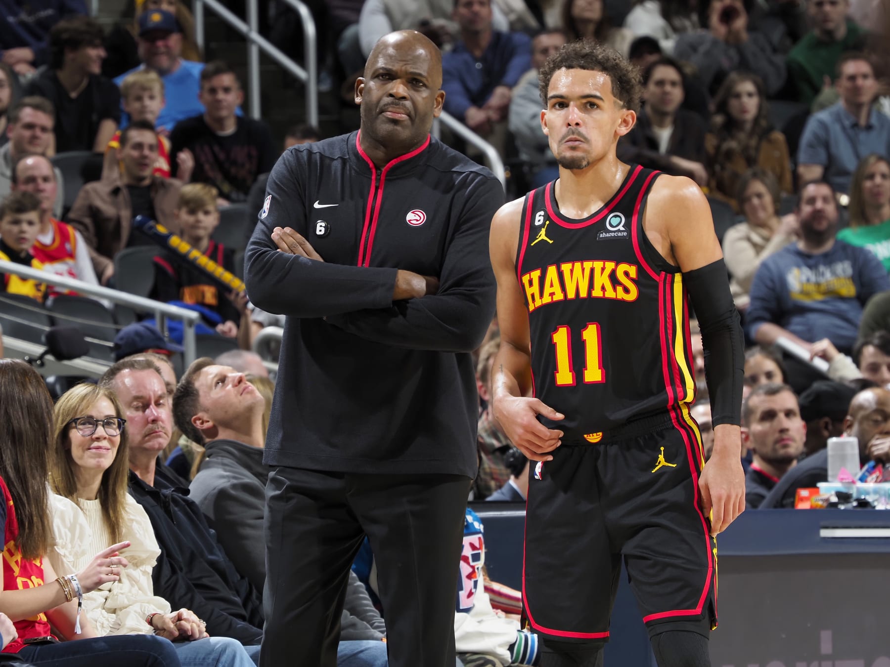 INDIANAPOLIS, IN - JANUARY 13: Head Coach Nate McMillan of the Atlanta Hawks and Trae Young #11 of the Atlanta Hawks looks on during the game against the Indiana Pacers  on January 13, 2023 at Gainbridge Fieldhouse in Indianapolis, Indiana. NOTE TO USER: User expressly acknowledges and agrees that, by downloading and or using this Photograph, user is consenting to the terms and conditions of the Getty Images License Agreement. Mandatory Copyright Notice: Copyright 2023 NBAE (Photo by Ron Hoskins/NBAE via Getty Images)