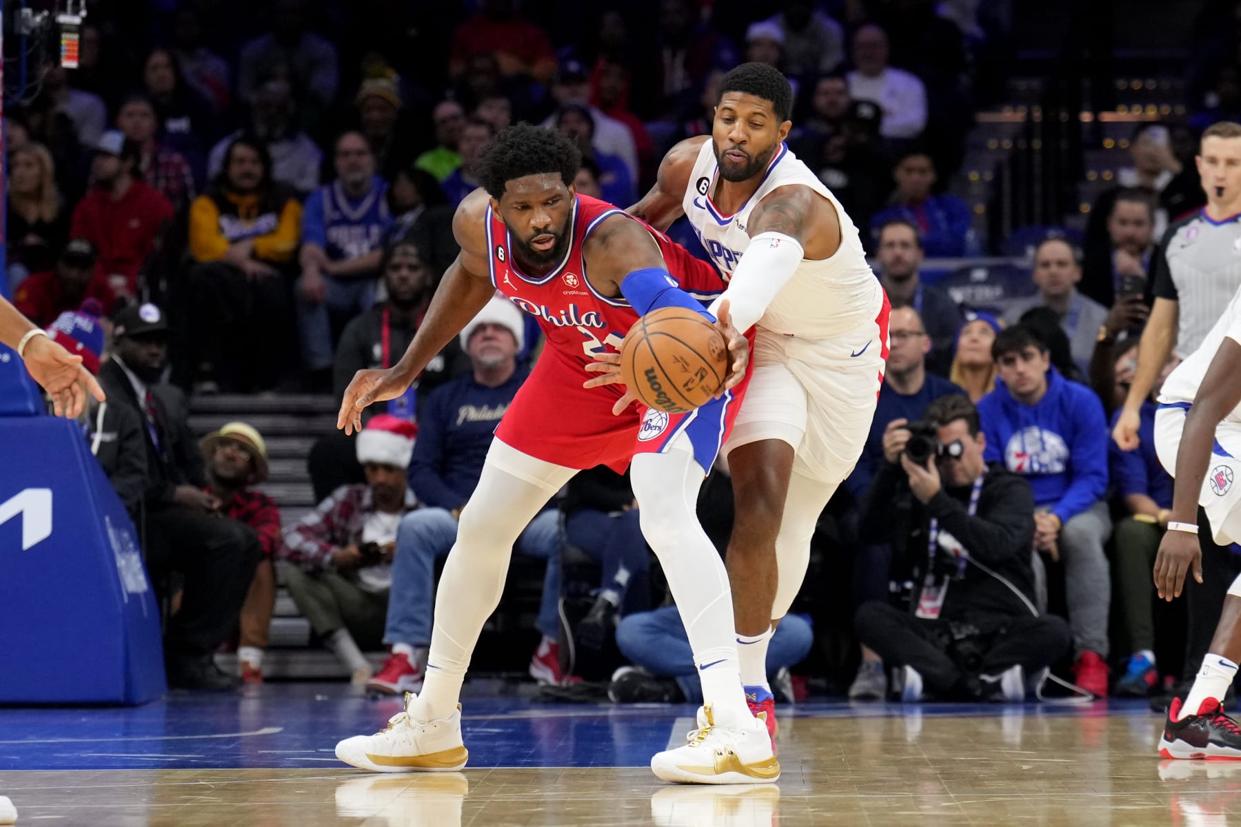 PHILADELPHIA, PA - DECEMBER 23: Paul George #13 of the LA Clippers attempts to steal the ball from Joel Embiid #21 of the Philadelphia 76ers during the game on December 23, 2022 at the Wells Fargo Center in Philadelphia, Pennsylvania NOTE TO USER: User expressly acknowledges and agrees that, by downloading and/or using this Photograph, user is consenting to the terms and conditions of the Getty Images License Agreement. Mandatory Copyright Notice: Copyright 2022 NBAE (Photo by Jesse D. Garrabrant/NBAE via Getty Images)