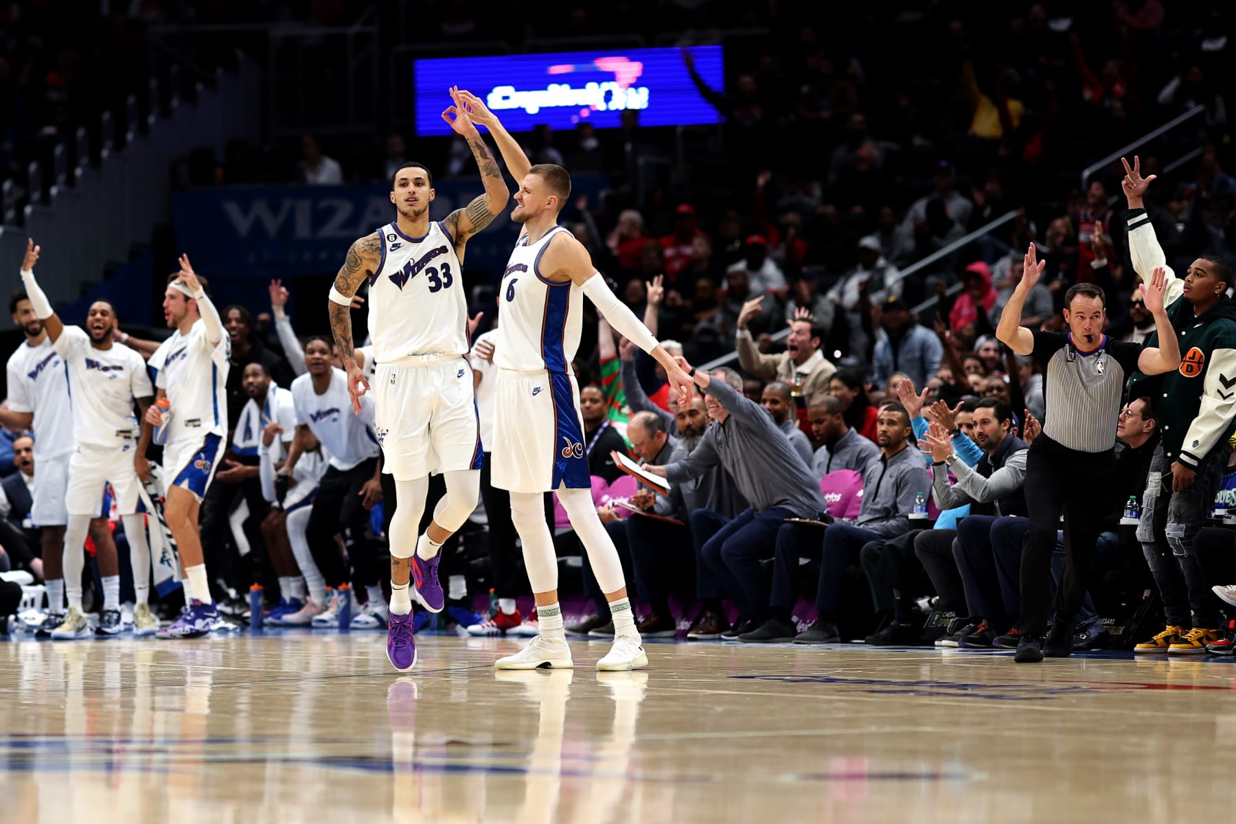 WASHINGTON, DC - NOVEMBER 28: Kristaps Porzingis #6 celebrates after hitting a three pointer in the first half with teammate Kyle Kuzma #33 of the Washington Wizards against the Minnesota Timberwolves at Capital One Arena on November 28, 2022 in Washington, DC. NOTE TO USER: User expressly acknowledges and agrees that, by downloading and or using this photograph, User is consenting to the terms and conditions of the Getty Images License Agreement. (Photo by Rob Carr/Getty Images)
