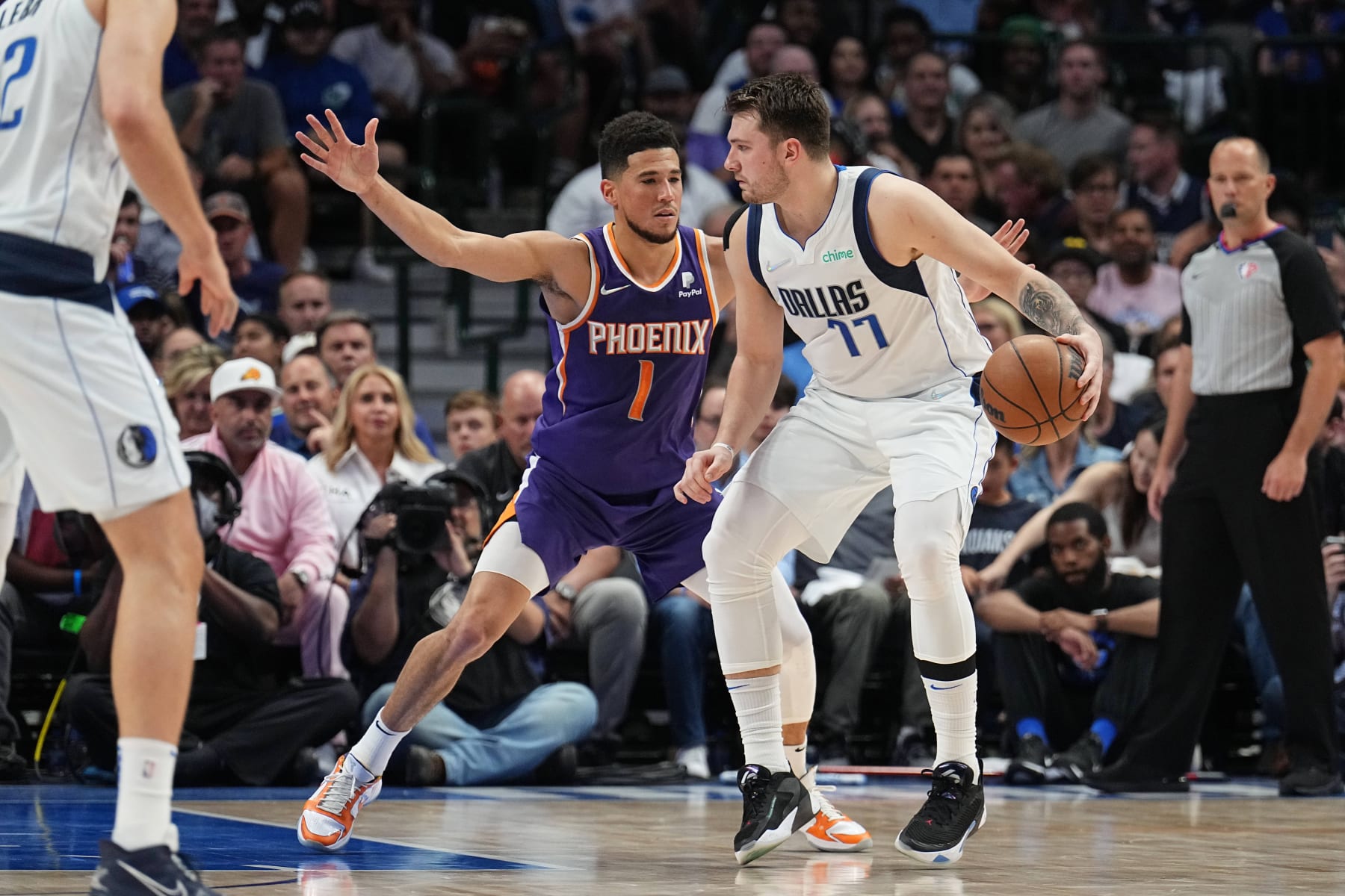DALLAS, TX - MAY 6: Devin Booker #1 of the Phoenix Suns plays defense on Luka Doncic #77 of the Dallas Mavericks during Game 3 of the 2022 NBA Playoffs Western Conference Semifinals on May 6, 2022 at the American Airlines Center in Dallas, Texas. NOTE TO USER: User expressly acknowledges and agrees that, by downloading and or using this photograph, User is consenting to the terms and conditions of the Getty Images License Agreement. Mandatory Copyright Notice: Copyright 2022 NBAE (Photo by Glenn James/NBAE via Getty Images)