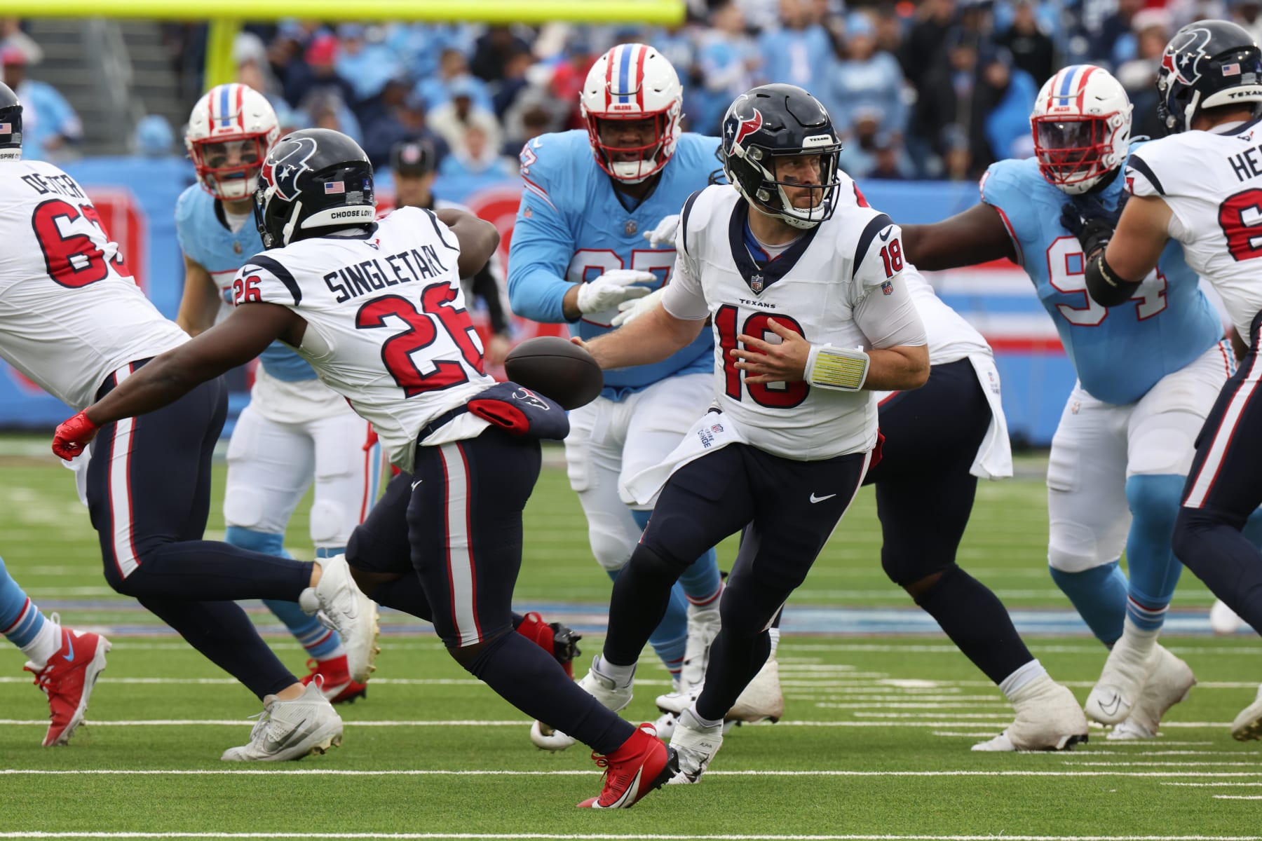 NASHVILLE, TN - DECEMBER 17:  Houston Texans quarterback Case Keenum (18) fakes a hand off to Houston Texans running back Devin Singletary (26) during a game between the Tennessee Titans and Houston Texans, December 17, 2023 at Nissan Stadium in Nashville, Tennessee. (Photo by Matthew Maxey/Icon Sportswire via Getty Images)