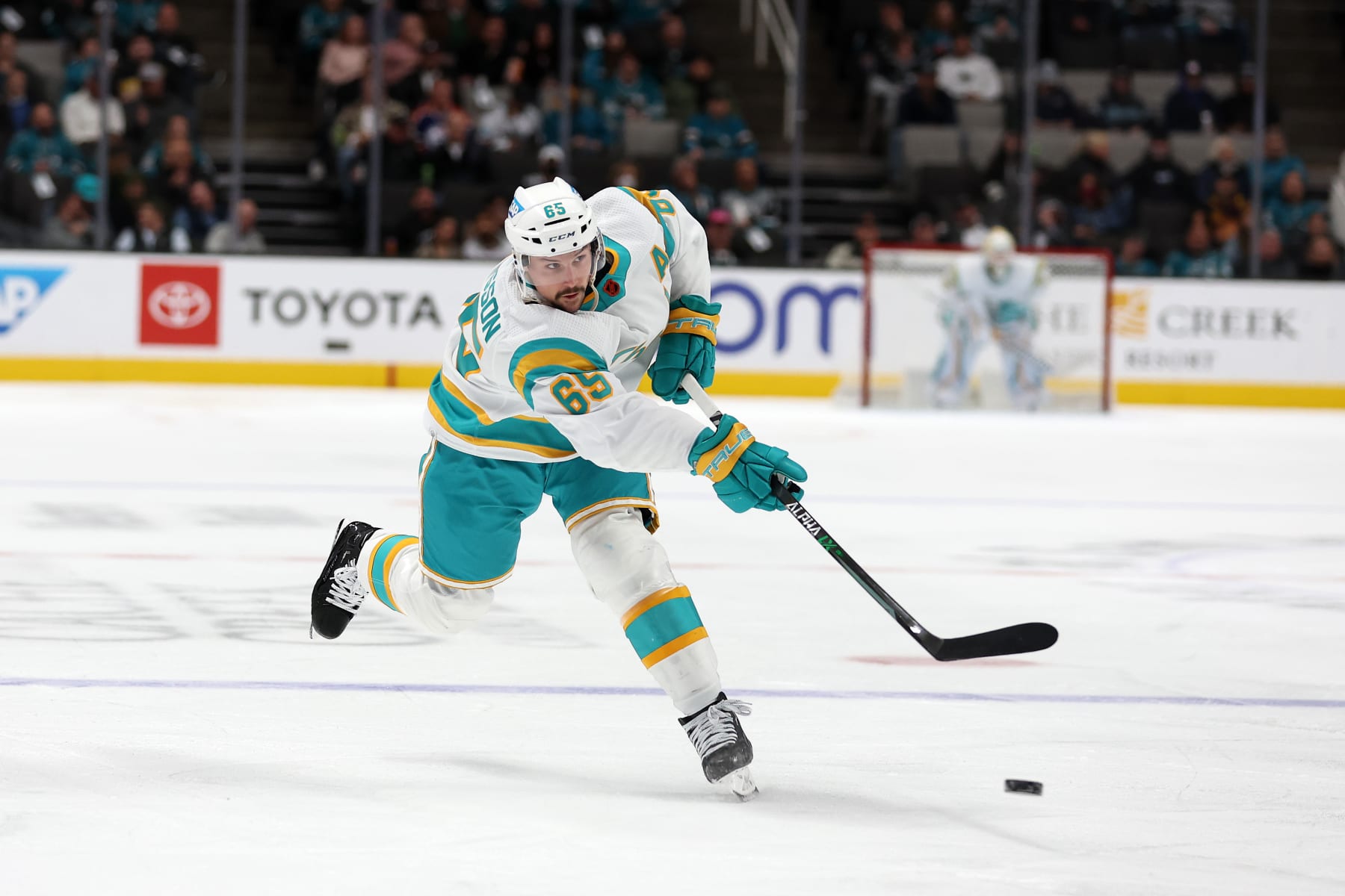 SAN JOSE, CALIFORNIA - DECEMBER 07: Erik Karlsson #65 of the San Jose Sharks takes a shot against the Vancouver Canucks at SAP Center on December 07, 2022 in San Jose, California. (Photo by Ezra Shaw/Getty Images)