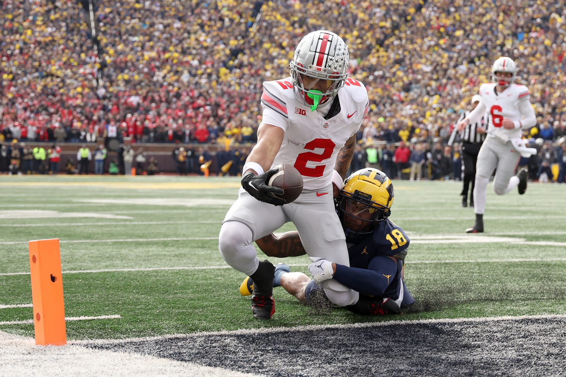 ANN ARBOR, MICHIGAN - NOVEMBER 25: Emeka Egbuka #2 of the Ohio State Buckeyes scores a touchdown against Ja'Den McBurrows #18 of the Michigan Wolverines during the second quarter in the game at Michigan Stadium on November 25, 2023 in Ann Arbor, Michigan. (Photo by Ezra Shaw/Getty Images)