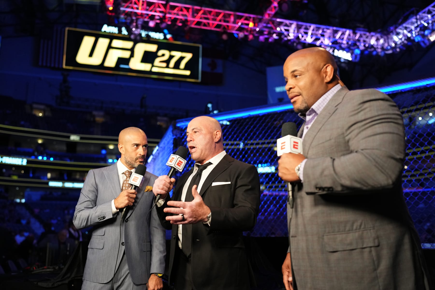 DALLAS, TEXAS - JULY 30: (L-R) UFC announcers Jon Anik, Joe Rogan and Daniel Cormier interact on camera during the UFC 277 event at American Airlines Center on July 30, 2022 in Dallas, Texas. (Photo by Chris Unger/Zuffa LLC)