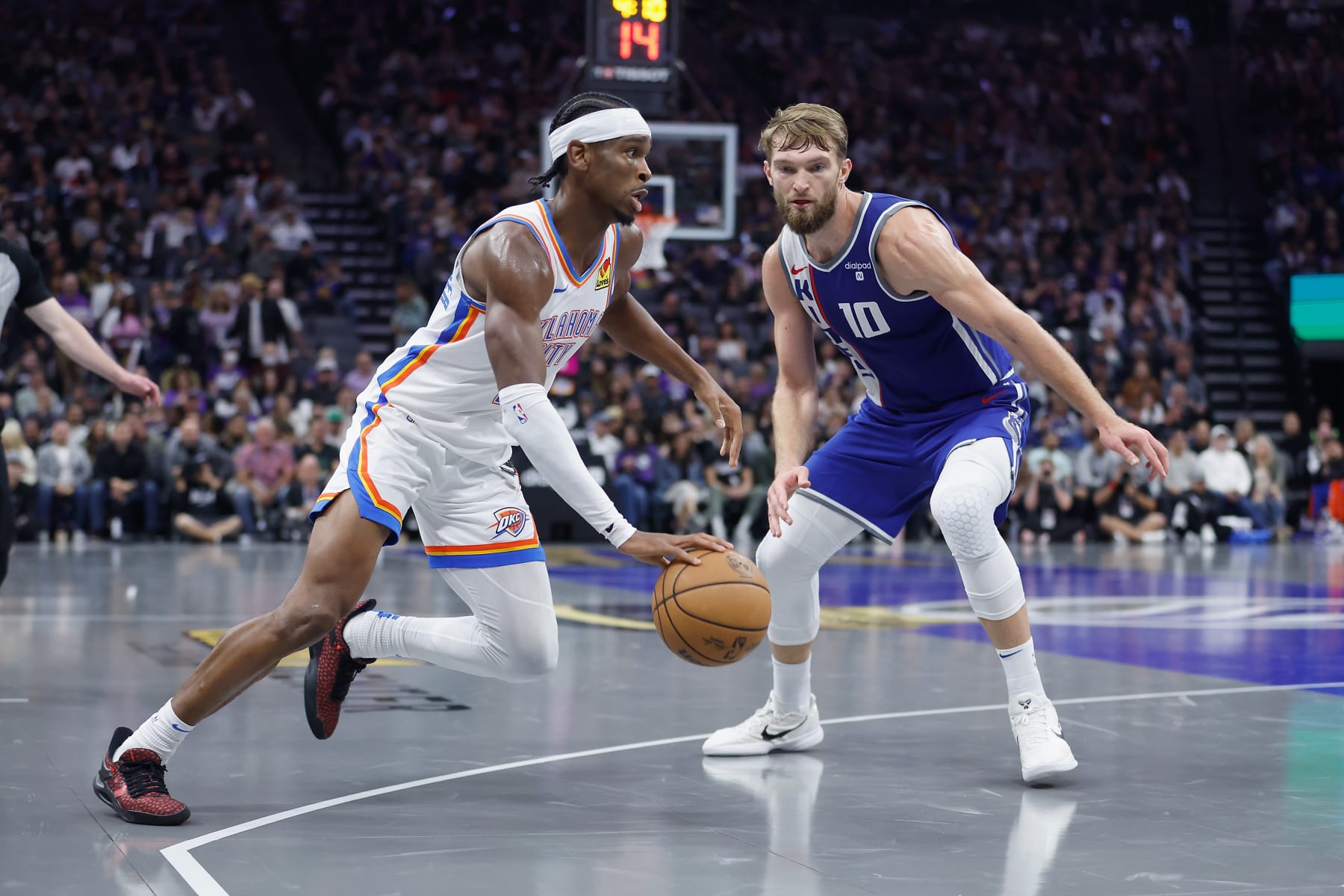 SACRAMENTO, CALIFORNIA - NOVEMBER 10: Shai Gilgeous-Alexander #2 of the Oklahoma City Thunder drives to the basket against Domantas Sabonis #10 of the Sacramento Kings in the third quarter during the NBA In-Season Tournament at Golden 1 Center on November 10, 2023 in Sacramento, California. NOTE TO USER: User expressly acknowledges and agrees that, by downloading and or using this photograph, User is consenting to the terms and conditions of the Getty Images License Agreement. (Photo by Lachlan Cunningham/Getty Images)