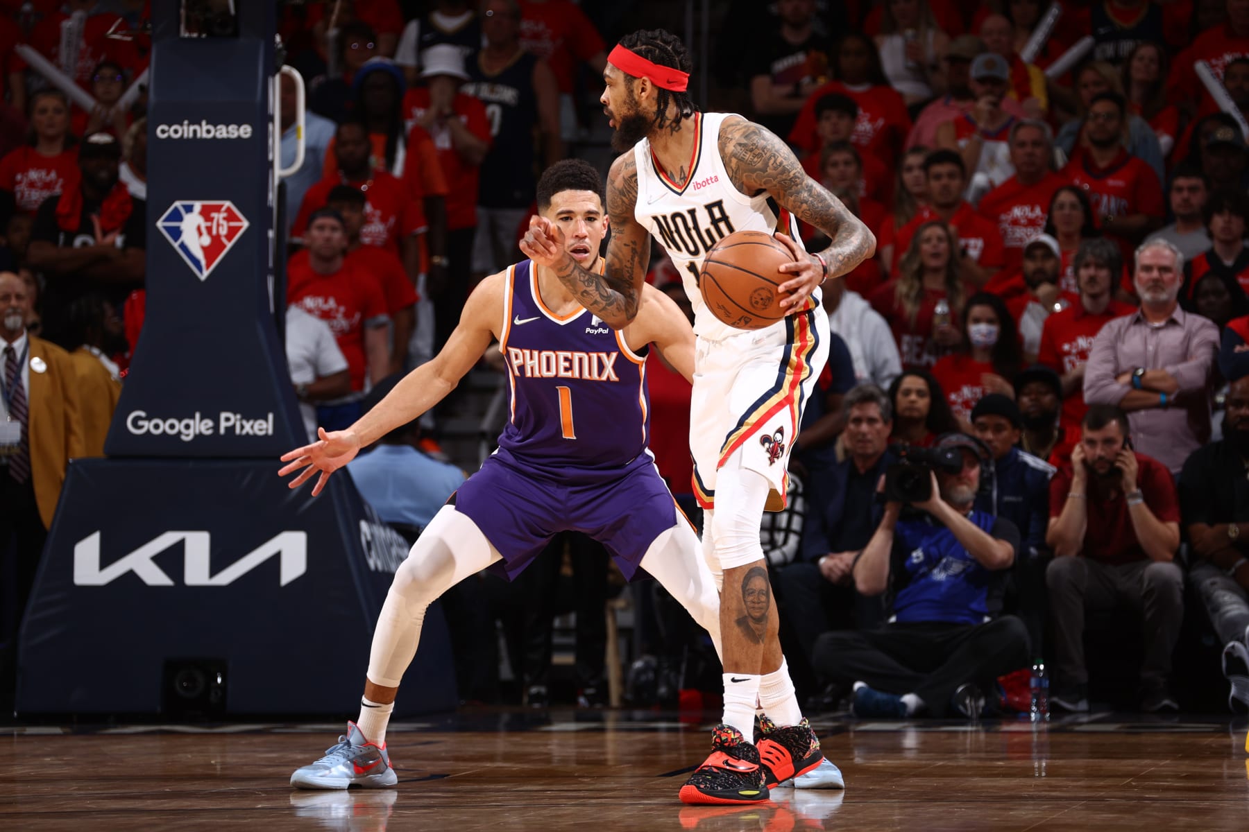NEW ORLEANS, LA - APRIL 28: Devin Booker #1 of the Phoenix Suns plays defense on Brandon Ingram #14 of the New Orleans Pelicans during Round 1 Game 6 of the 2022 NBA Playoffs on April 28, 2022 at the Smoothie King Center in New Orleans, Louisiana. NOTE TO USER: User expressly acknowledges and agrees that, by downloading and or using this Photograph, user is consenting to the terms and conditions of the Getty Images License Agreement. Mandatory Copyright Notice: Copyright 2022 NBAE (Photo by Ned Dishman/NBAE via Getty Images)
