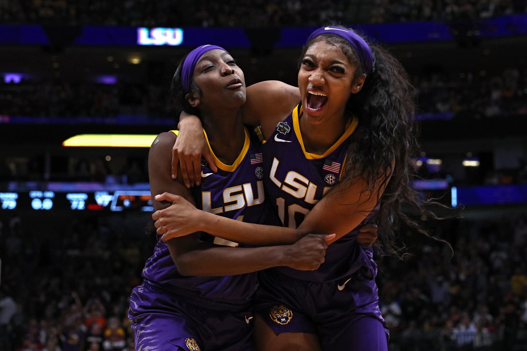 DALLAS, TEXAS - MARCH 31: Angel Reese #10 and Flau'jae Johnson #4 of the LSU Lady Tigers react after the 79-72 victory over the Virginia Tech Hokies during the 2023 NCAA Women's Basketball Tournament Final Four semifinal game at American Airlines Center on March 31, 2023 in Dallas, Texas. (Photo by Tom Pennington/Getty Images)