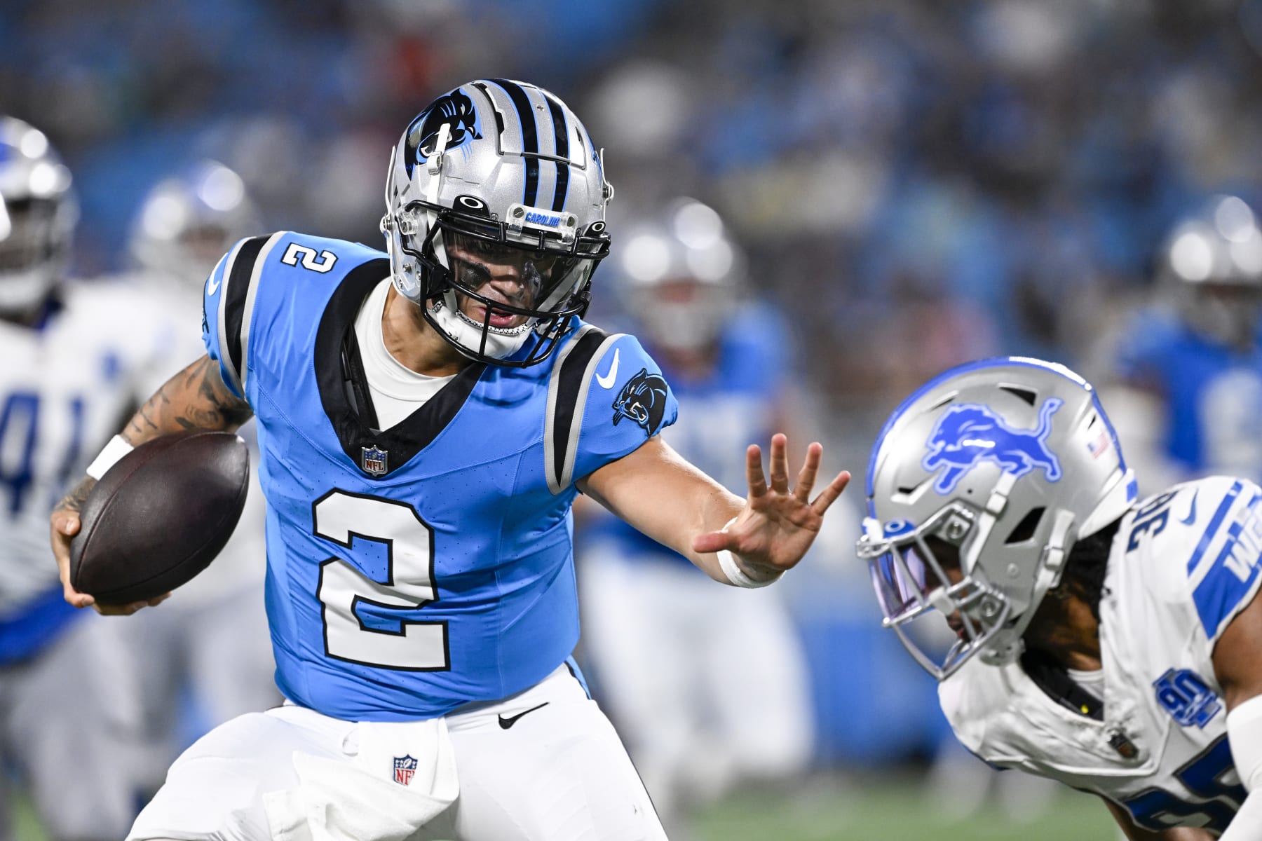 CHARLOTTE, NORTH CAROLINA - AUGUST 25: Matt Corral #2 of the Carolina Panthers stiff-arms Steven Gilmore #36 of the Detroit Lions during the second half of a preseason game at Bank of America Stadium on August 25, 2023 in Charlotte, North Carolina. (Photo by Grant Halverson/Getty Images)
