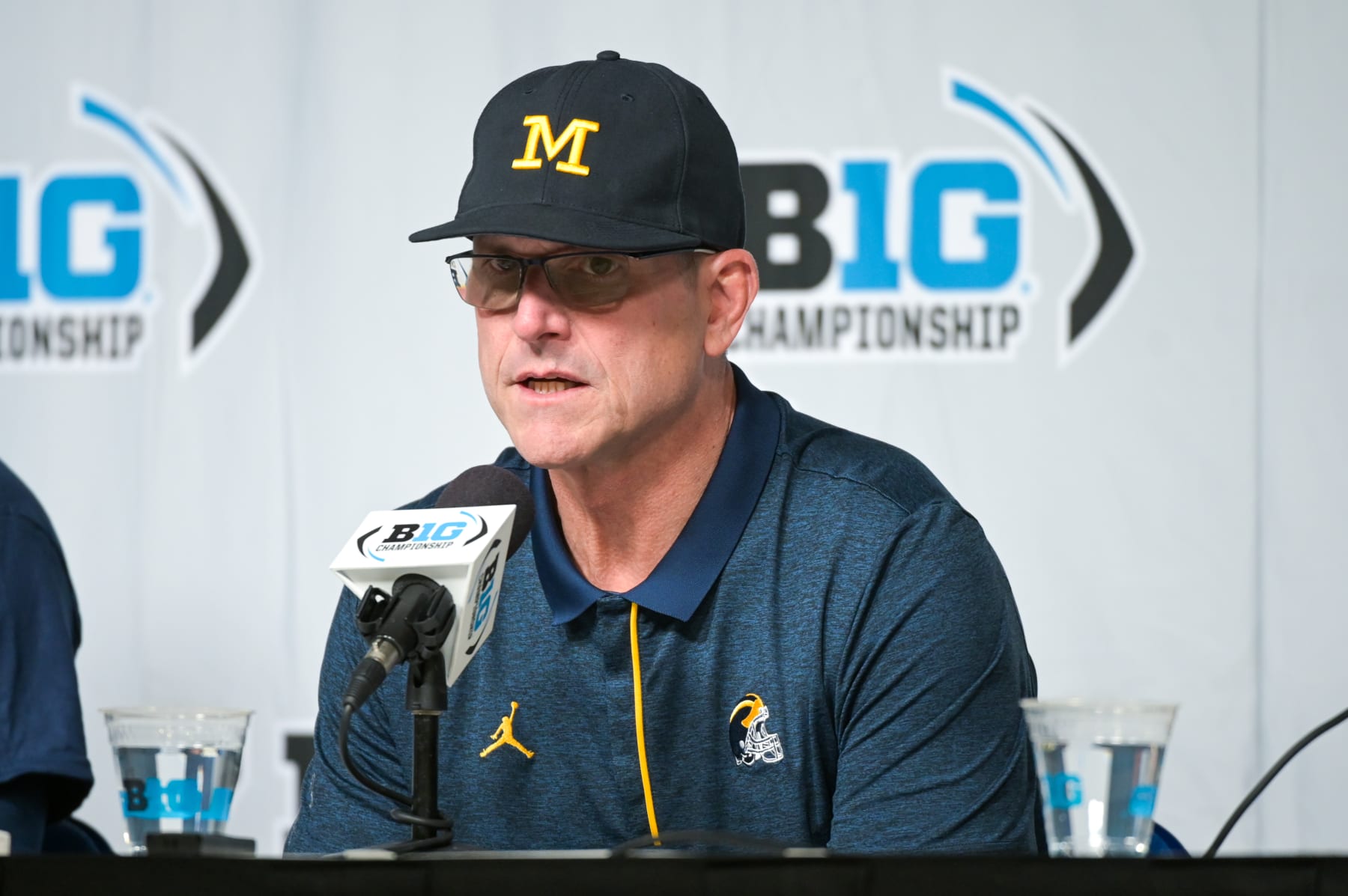 INDIANAPOLIS, INDIANA - DECEMBER 03: Head Football Coach Jim Harbaugh of the Michigan Wolverines speaks to press after winning the Big Ten football championship game against the Purdue Boilermakers at Lucas Oil Stadium on December 03, 2022 in Indianapolis, Indiana. The Michigan Wolverines won the game 43-22 over the Purdue Boilermakers. (Photo by Aaron J. Thornton/Getty Images)