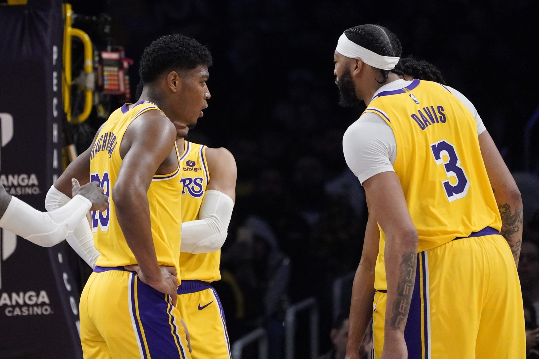 Los Angeles Lakers forward Rui Hachimura, left, and forward Anthony Davis chat during the second half of an NBA basketball game against the San Antonio Spurs Wednesday, Jan. 25, 2023, in Los Angeles. (AP Photo/Mark J. Terrill)