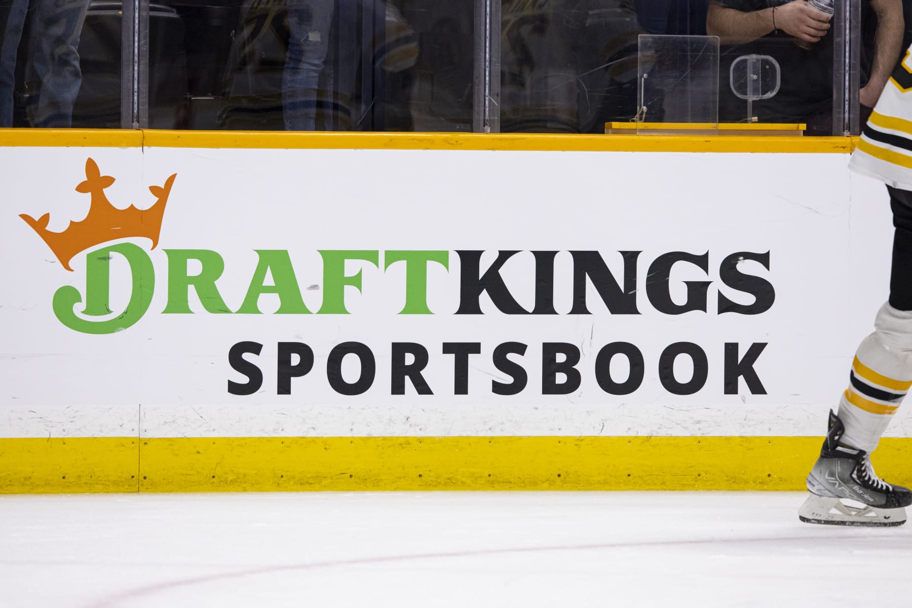 NASHVILLE, TN - FEBRUARY 16:  Detail view of a DraftKings Sportsbook ad as Boston Bruins players skate in warm-ups prior to the game against the Nashville Predators at Bridgestone Arena on February 16, 2023 in Nashville, Tennessee. (Photo by Brett Carlsen/Getty Images)