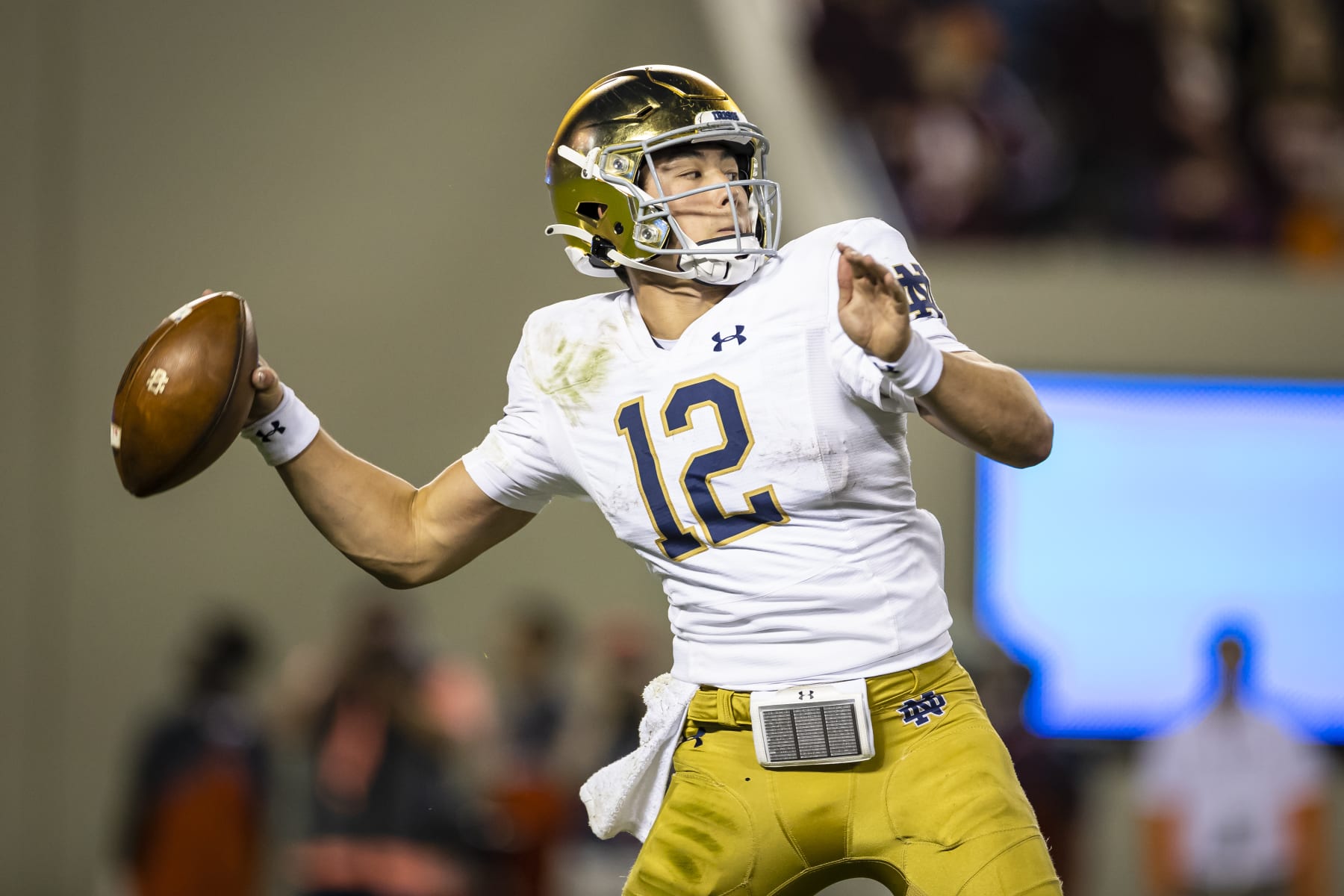 BLACKSBURG, VA - OCTOBER 09: Tyler Buchner #12 of the Notre Dame Fighting Irish attempts a pass against the Virginia Tech Hokies during the second half of the game at Lane Stadium on October 9, 2021 in Blacksburg, Virginia. (Photo by Scott Taetsch/Getty Images)