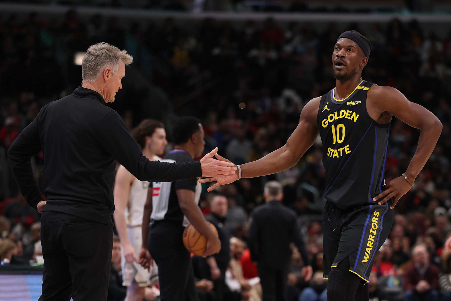 CHICAGO, ILLINOIS - FEBRUARY 08: Head coach Steve Kerr of the Golden State Warriors high fives Jimmy Butler #10 against the Chicago Bulls during the second half at the United Center on February 08, 2025 in Chicago, Illinois. NOTE TO USER: User expressly acknowledges and agrees that, by downloading and or using this photograph, User is consenting to the terms and conditions of the Getty Images License Agreement.  (Photo by Michael Reaves/Getty Images)