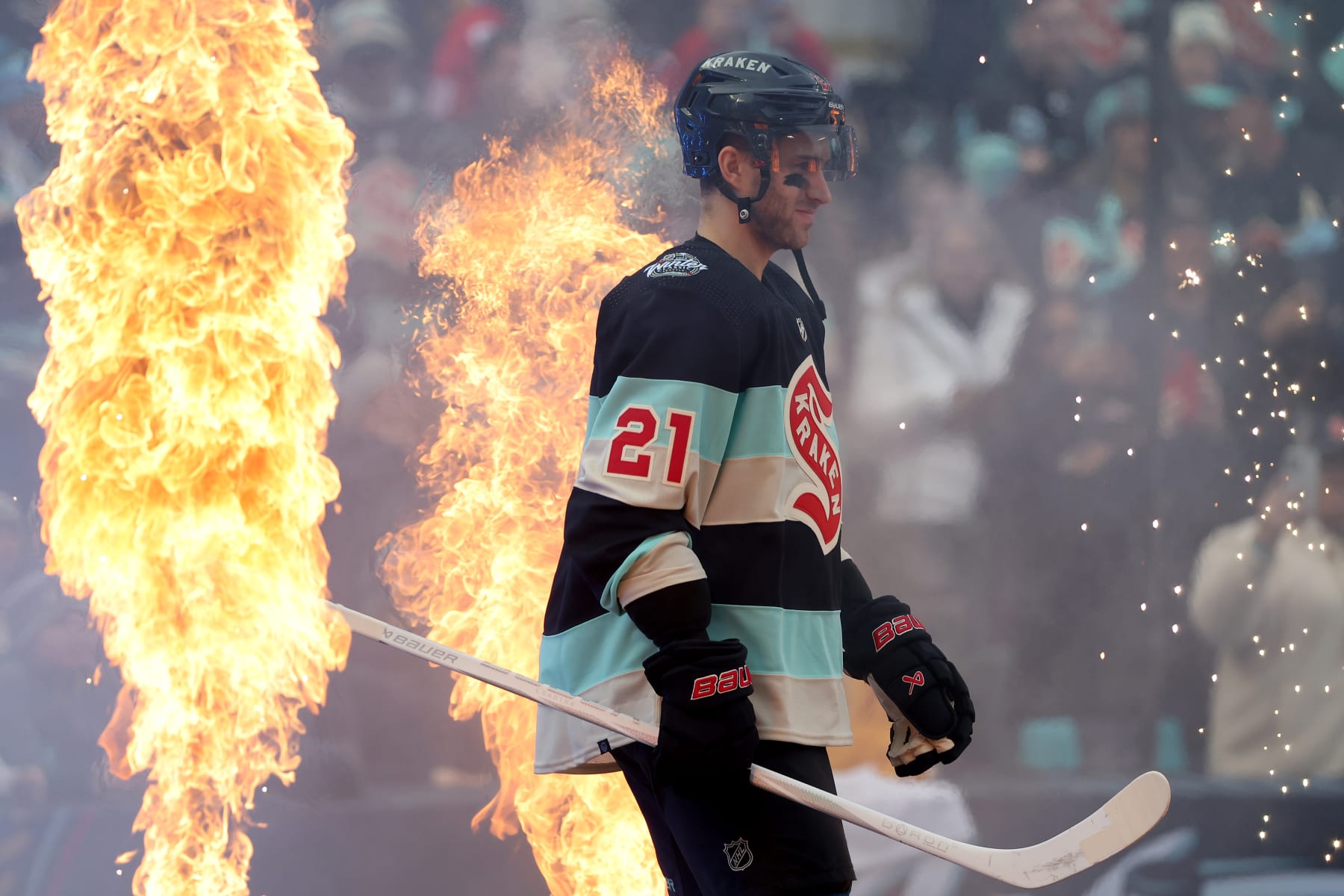 SEATTLE, WASHINGTON - JANUARY 01:  Alex Wennberg #21 of the Seattle Kraken walks toward the ice prior to the game against the Vegas Golden Knights at T-Mobile Park on January 01, 2024 in Seattle, Washington. (Photo by Steph Chambers/Getty Images)