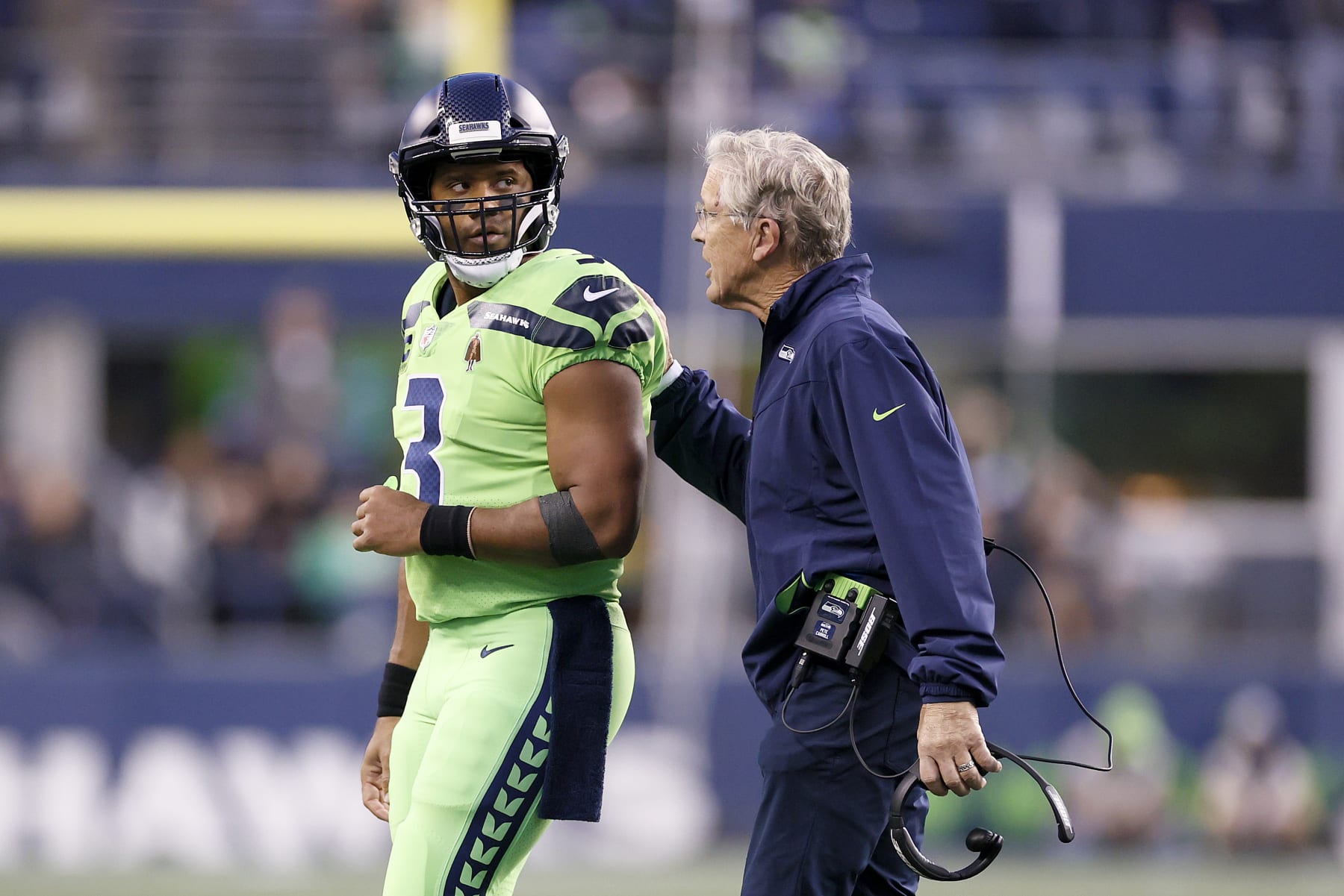 SEATTLE, WASHINGTON - OCTOBER 07: Quarterback Russell Wilson #3 talks with head coach Pete Carroll of the Seattle Seahawks during the first half against the Los Angeles Rams at Lumen Field on October 07, 2021 in Seattle, Washington. (Photo by Steph Chambers/Getty Images)