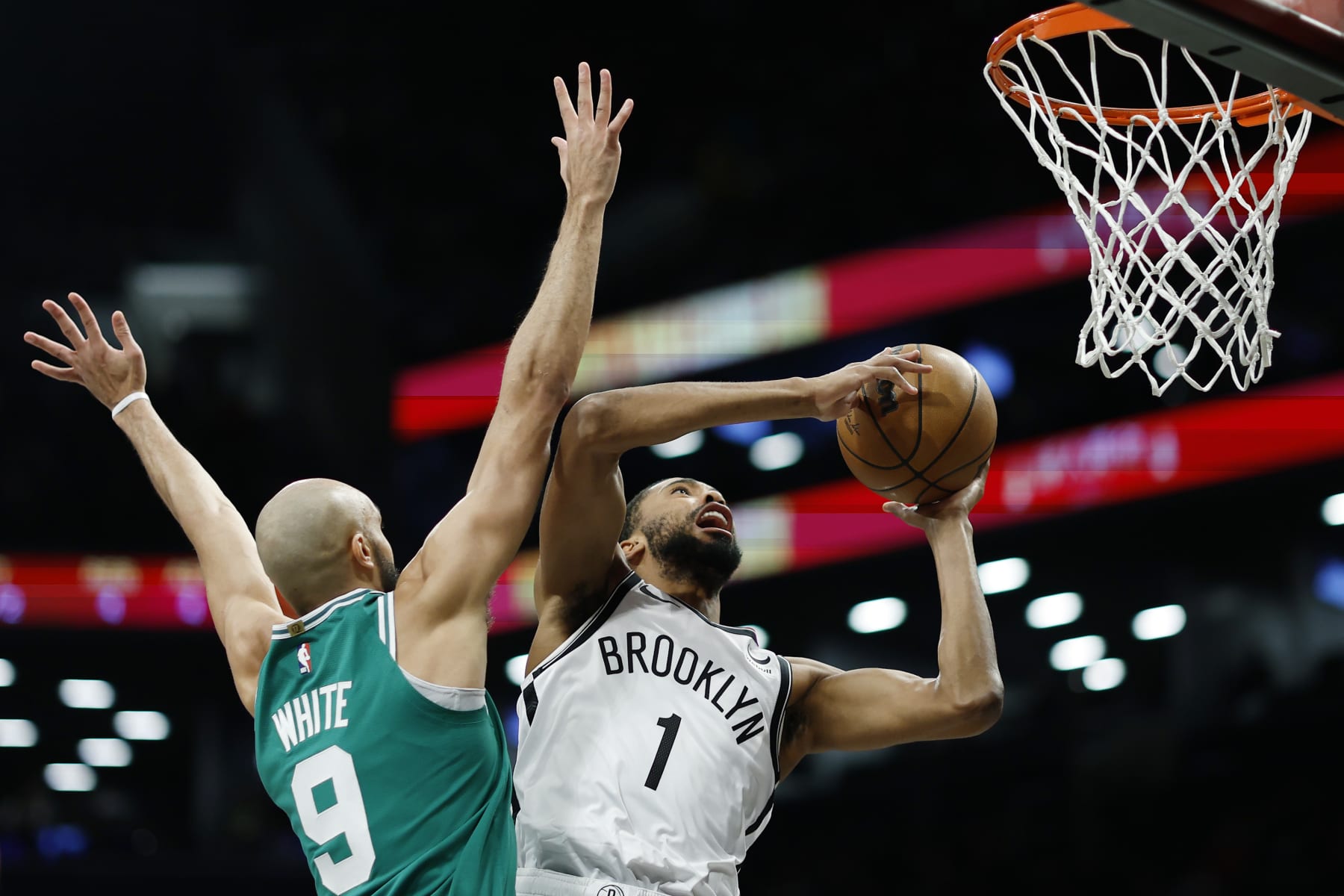 NEW YORK, NEW YORK - FEBRUARY 13: Mikal Bridges #1 of the Brooklyn Nets goes to the basket as Derrick White #9 of the Boston Celtics defends during the first half at Barclays Center on February 13, 2024 in the Brooklyn borough of New York City. NOTE TO USER: User expressly acknowledges and agrees that, by downloading and or using this photograph, User is consenting to the terms and conditions of the Getty Images License Agreement. (Photo by Sarah Stier/Getty Images)