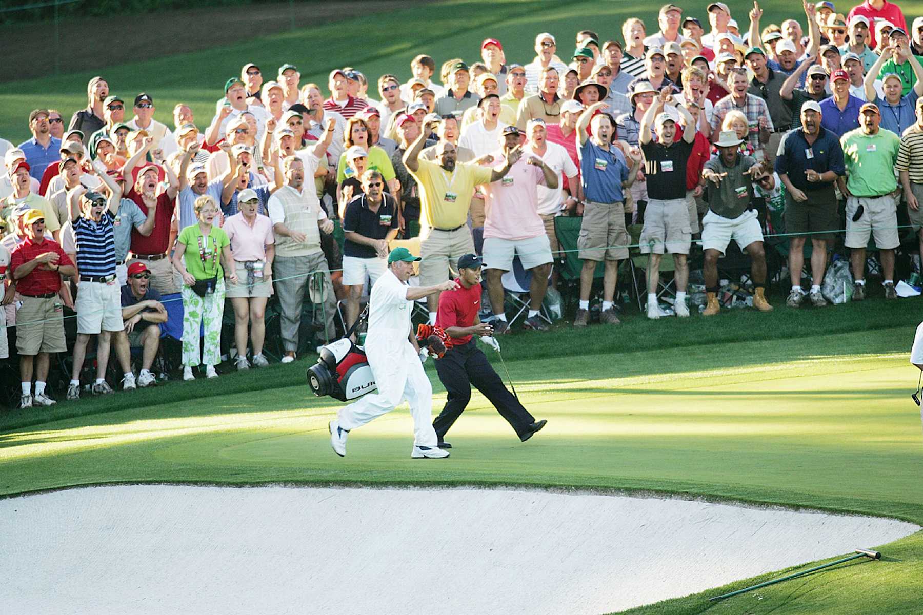 UNITED STATES - APRIL 10:  Golf: The Masters, Tiger Woods and caddie Steve Williams victorious after making 16th hole chip during final round on Sunday at Augusta National, View of fans, Augusta, GA 4/10/2005  (Photo by Al Tielemans/Sports Illustrated via Getty Images)  (SetNumber: X73300 TK6)