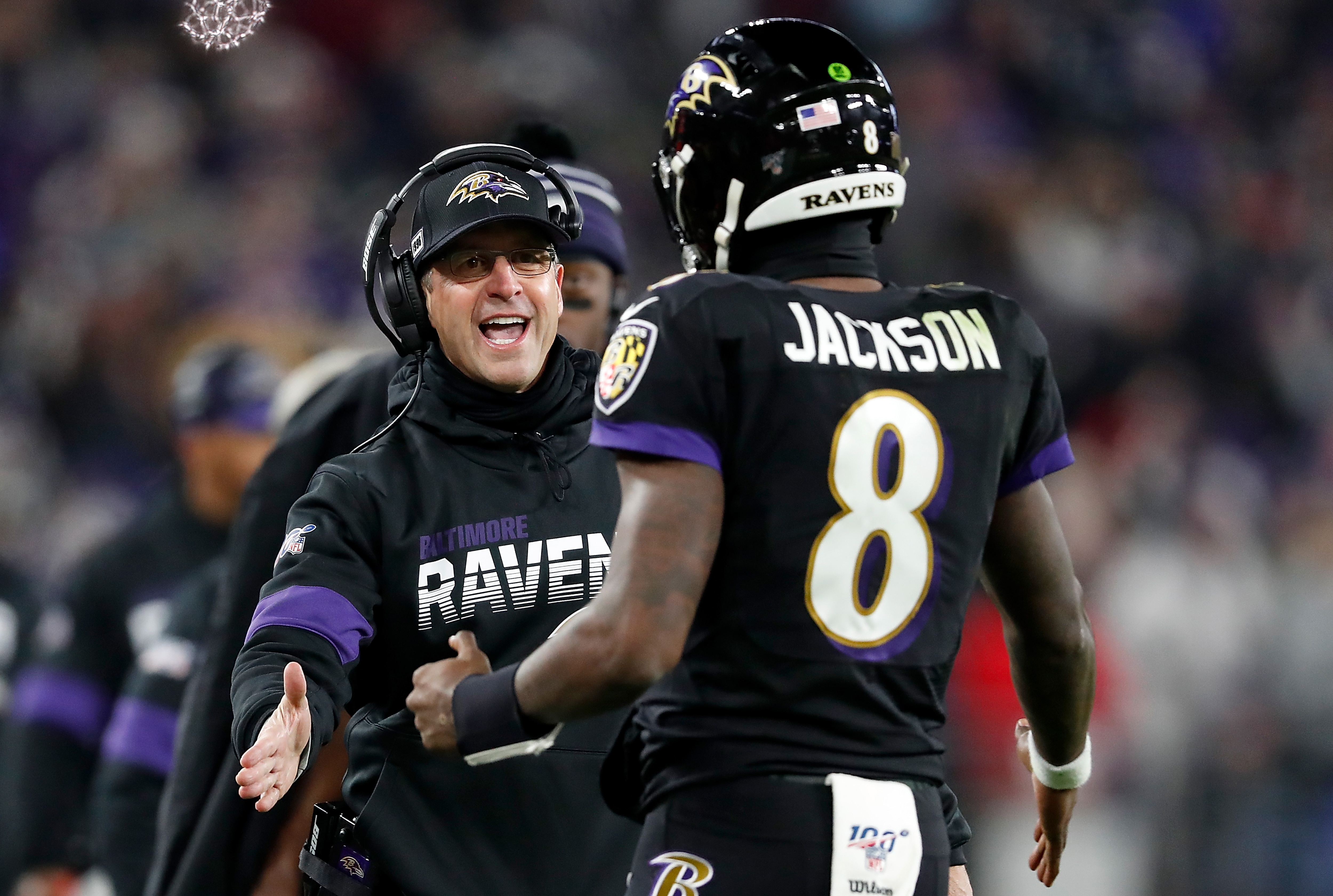 BALTIMORE, MARYLAND - DECEMBER 12: Head coach John Harbaugh of the Baltimore Ravens and quarterback Lamar Jackson #8 celebrate a touchdown in the third quarter of the game against the New York Jets at M&T Bank Stadium on December 12, 2019 in Baltimore, Maryland. (Photo by Scott Taetsch/Getty Images)