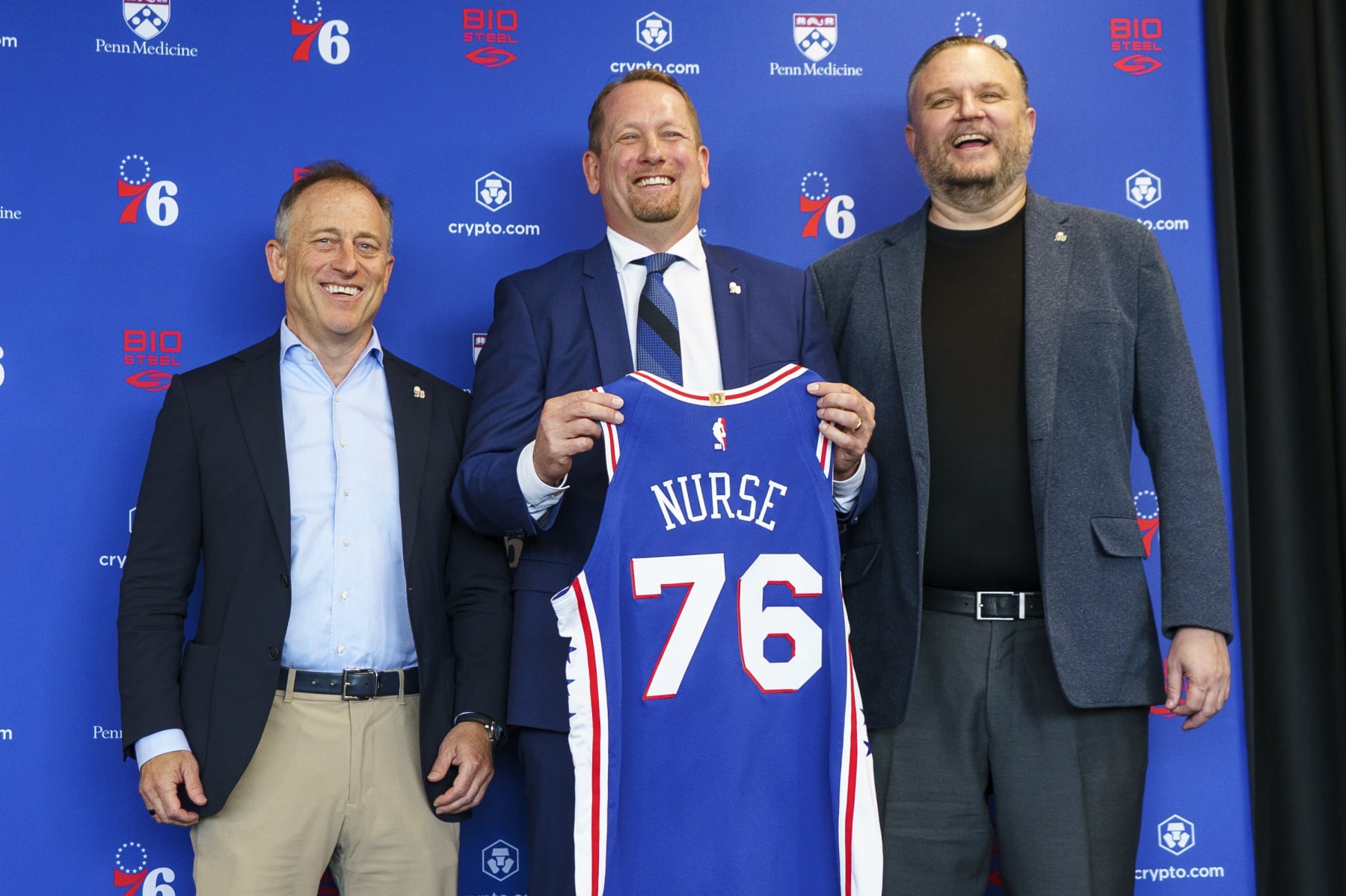 Philadelphia 76ers head coach Nick Nurse, center, holds up a jersey flanked by owner Josh Harris, left, and president Daryl Morey, right, after taking questions from the media during a press conference at the NBA basketball team's facility, Thursday, June 1, 2023, in Camden, N.J. (AP Photo/Chris Szagola)