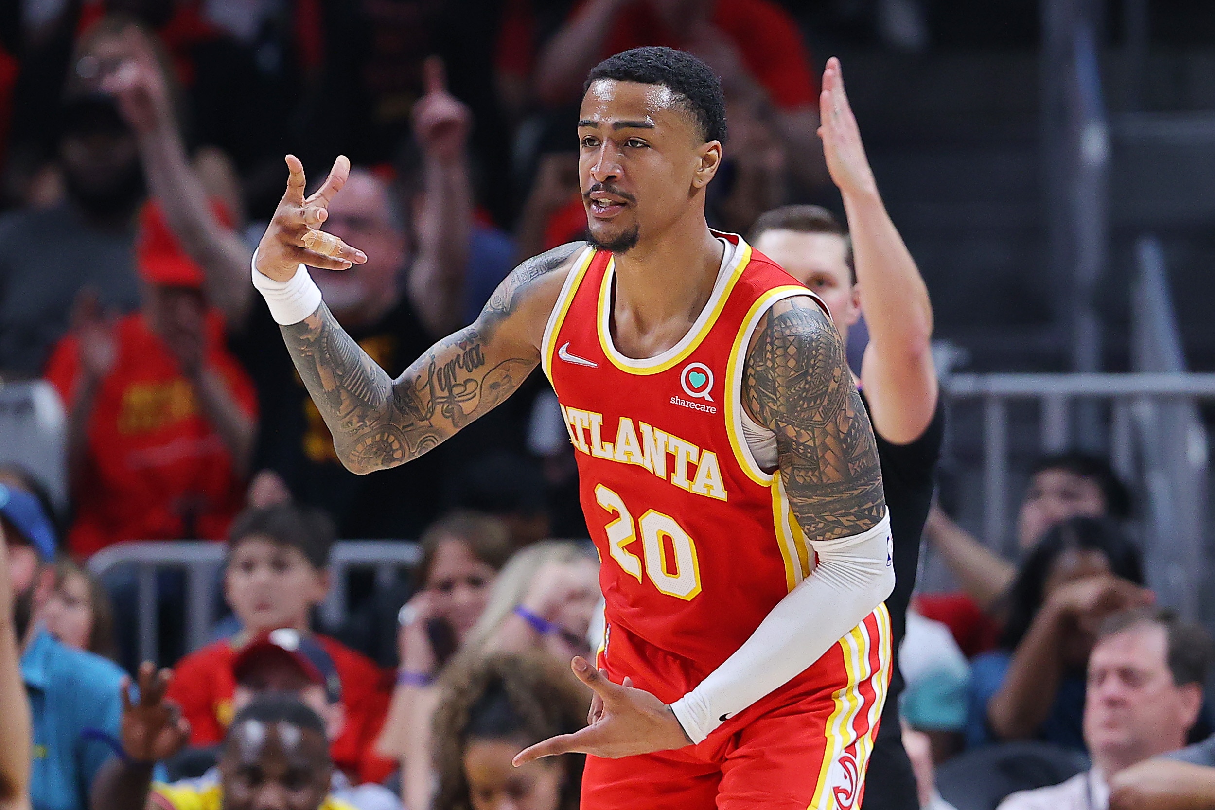 ATLANTA, GEORGIA - APRIL 22: John Collins #20 of the Atlanta Hawks celebrates a three pointer against the Miami Heat during the second quarter in Game Three of the Eastern Conference First Round at State Farm Arena on April 22, 2022 in Atlanta, Georgia. NOTE TO USER: User expressly acknowledges and agrees that, by downloading and or using this photograph, User is consenting to the terms and conditions of the Getty Images License Agreement.  (Photo by Kevin C. Cox/Getty Images)